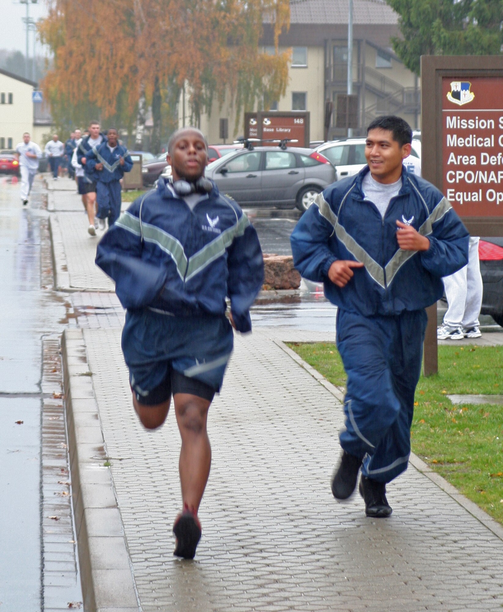 SPANGDAHLEM AIR BASE, Germany – Airman 1st Class Christopher Simmons, left, and Staff Sgt. Rodel Ramirez, both from the 52nd Logistics Readiness Squadron, finish a five-kilometer charity run Nov. 9. The event raised more than $3,500 to benefit the Landstuhl Fisher House through the Combined Federal Campaign. (U.S. Air Force photo)