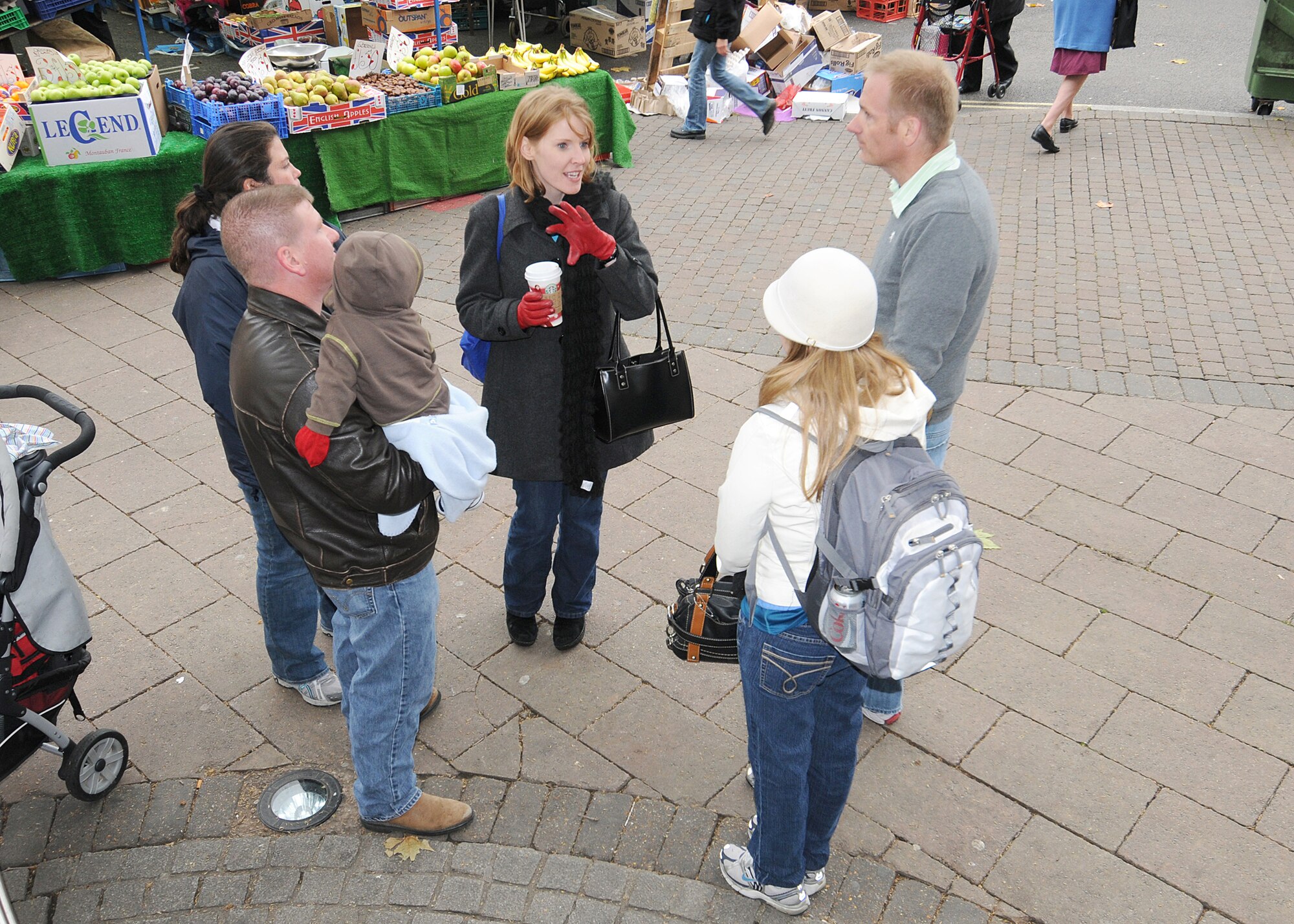 RAF MILDENHALL, England -- Jennifer Johnson, Airman and Family Readiness Center community readiness consultant (center), shows RAF Mildenhall newcomers around the local market during the Newcomer's Bury Bus Tour in Bury St. Edmunds Nov. 11, 2010.  This trip is offered on the second Wednesday of the month to introduce newcomers to the local area.  (U.S. Air Force photo/Senior Airman Tabitha M. Lee)