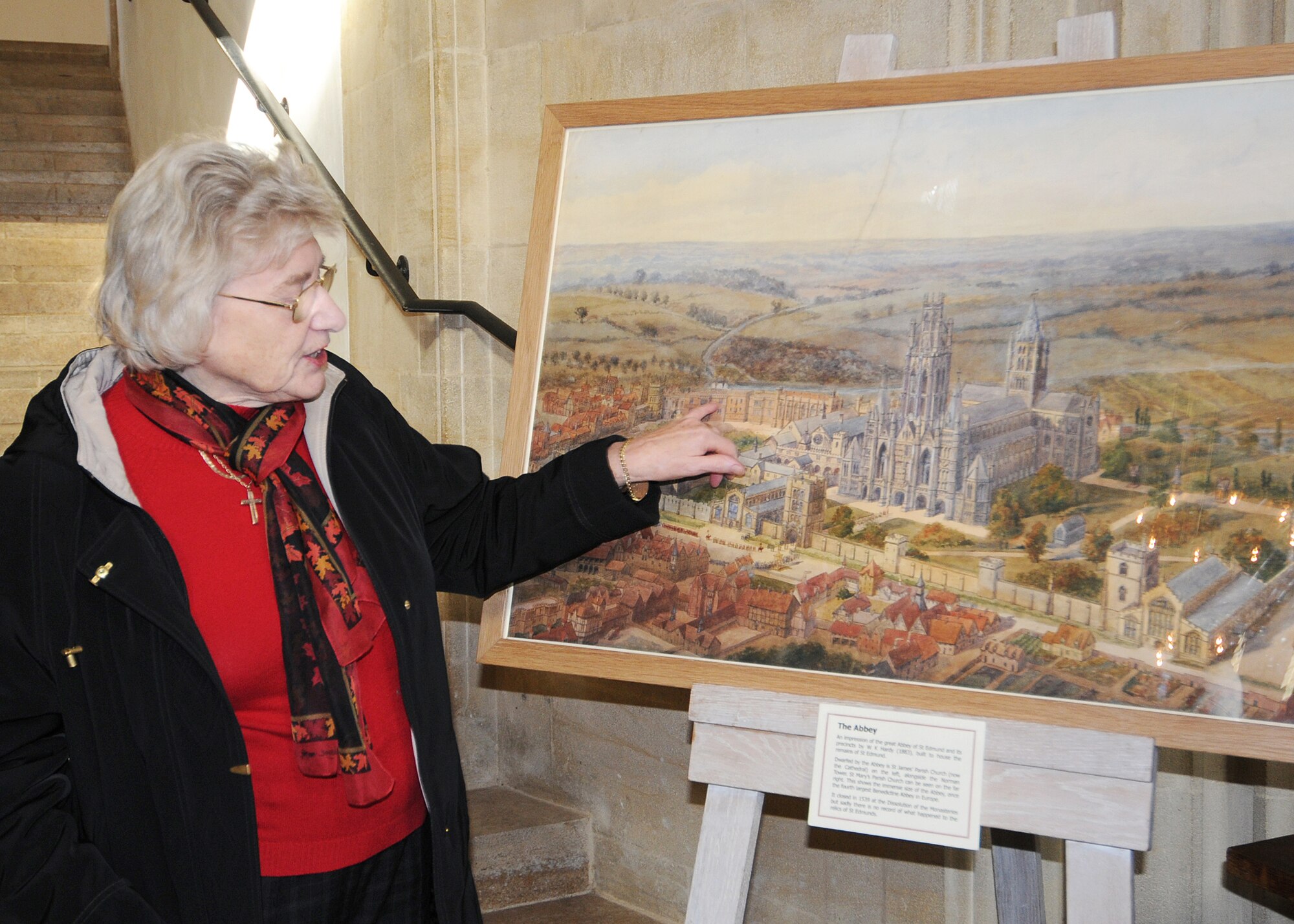 RAF MILDENHALL, England -- June Ley, an official St. Edmundsbury Cathedral tour guide, tells the history of a painting of The Abbey in Bury St. Edmunds Nov. 11, 2010.  This tour is part of the Newcomer's Bury Bus Tour offered monthly by the Airman and Family Readiness Center.  (U.S. Air Force photo/Senior Airman Tabitha M. Lee)