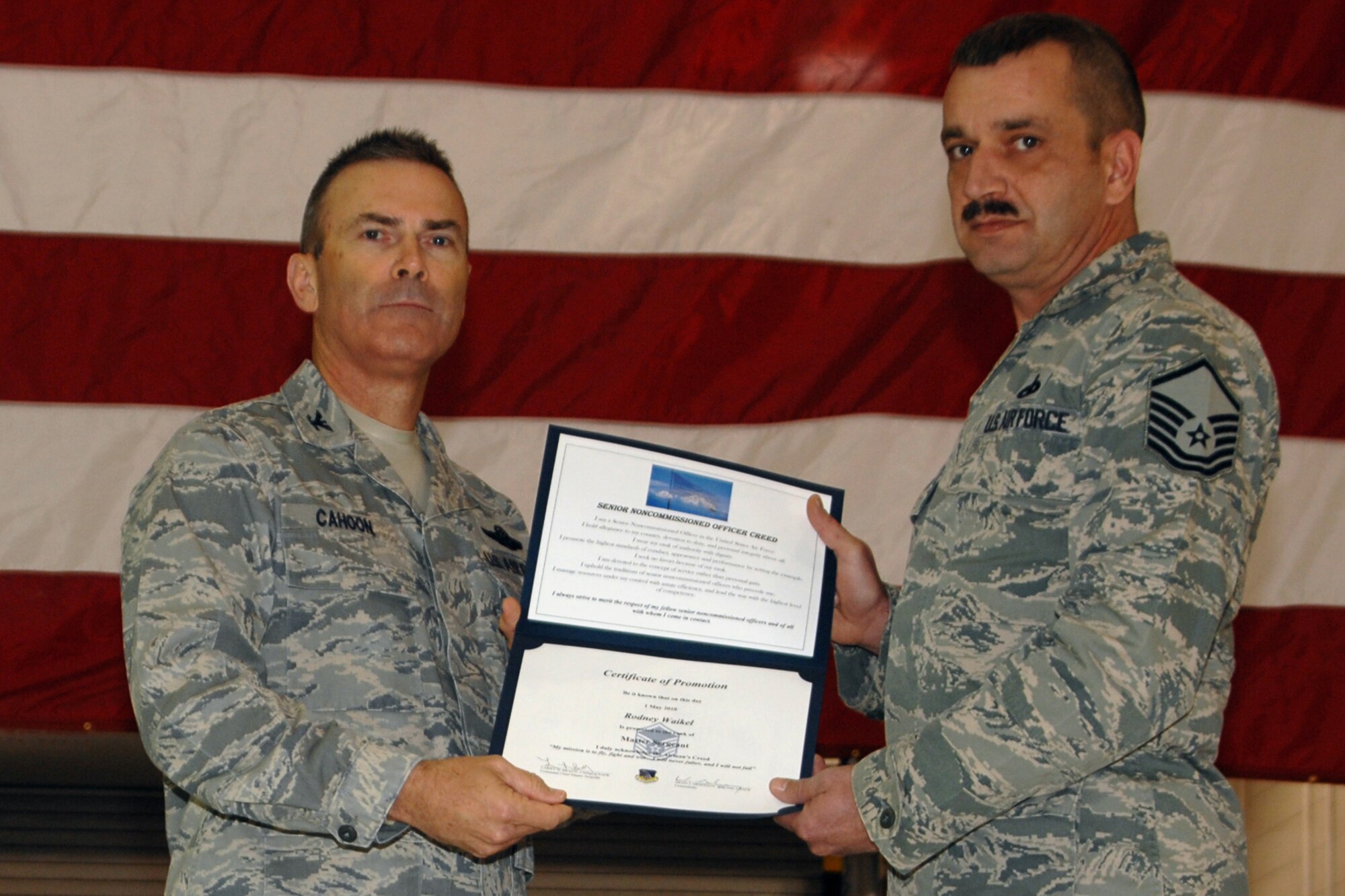 GRISSOM AIR RESERVE BASE, Ind. -- Master Sgt. Rodney Waikel is presented with a certificate of promotion by Col. William T. "Tim" Cahoon during a special induction ceremony held here during the November unit training assembly. Sergeant Waikel, pneudraulic systems supervisor with the 434th Maintenance Squadron, and two other Grissom Airmen were inducted into the senior noncommissioned officer ranks. Colonel Cahoon is the 434th Air Refueling Wing commander. (U.S. Air Force photo/Senior Airman Carl Berry)
