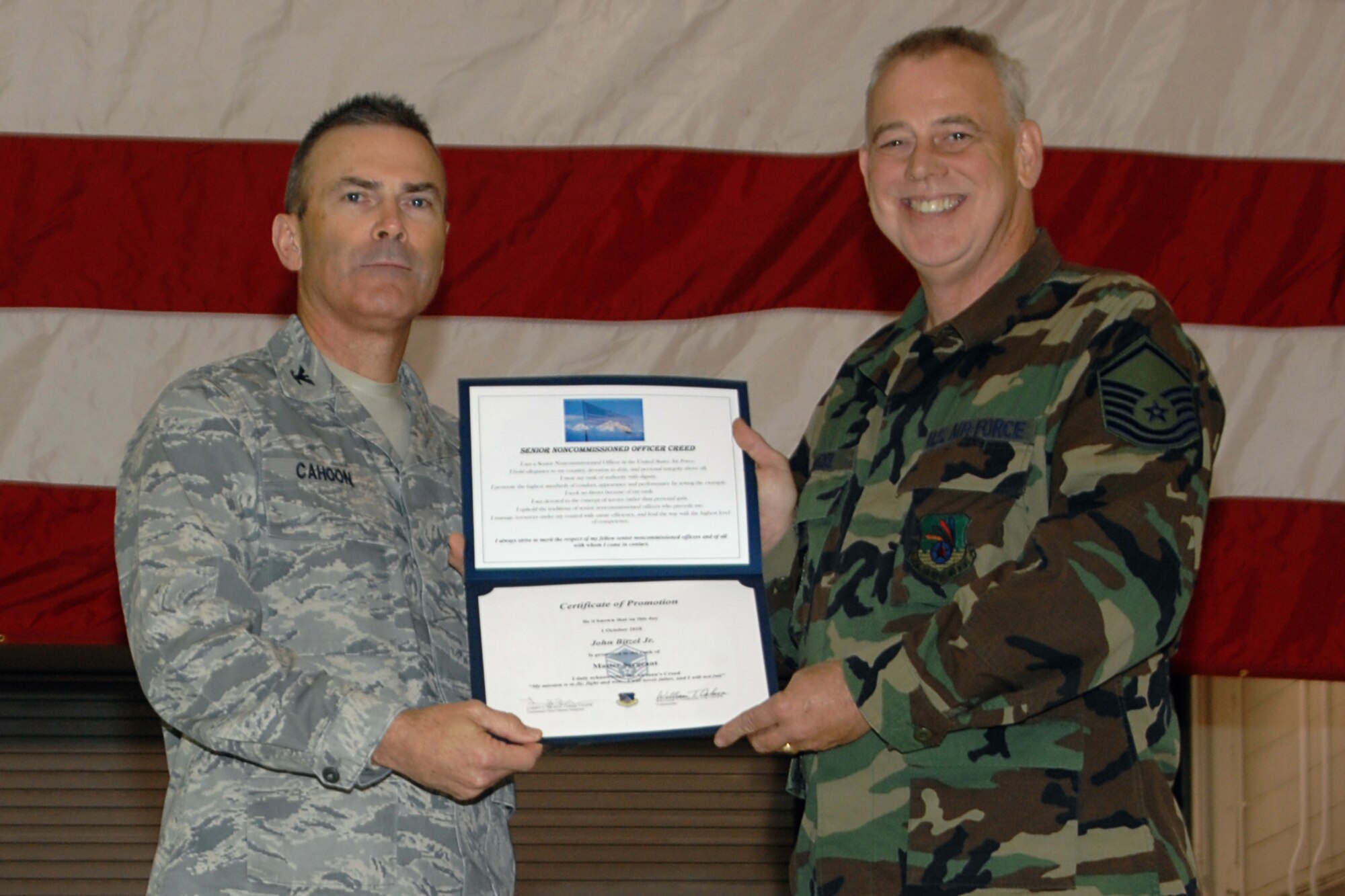 GRISSOM AIR RESERVE BASE, Ind. -- Col. William T. "Tim" Cahoon presents Master Sgt. John E. Bitzel, Jr., with a certificate of promotion as he is inducted into the senior noncommissioned officer ranks during the November unit training assembly. Sergeant Bitzel is a combat crew communications specialist with the 434th Operations Support Squadron. Colonel Cahoon is the 434th Air Refueling Wing commander. (U.S. Air Force photo/Senior Airman Carl Berry)

