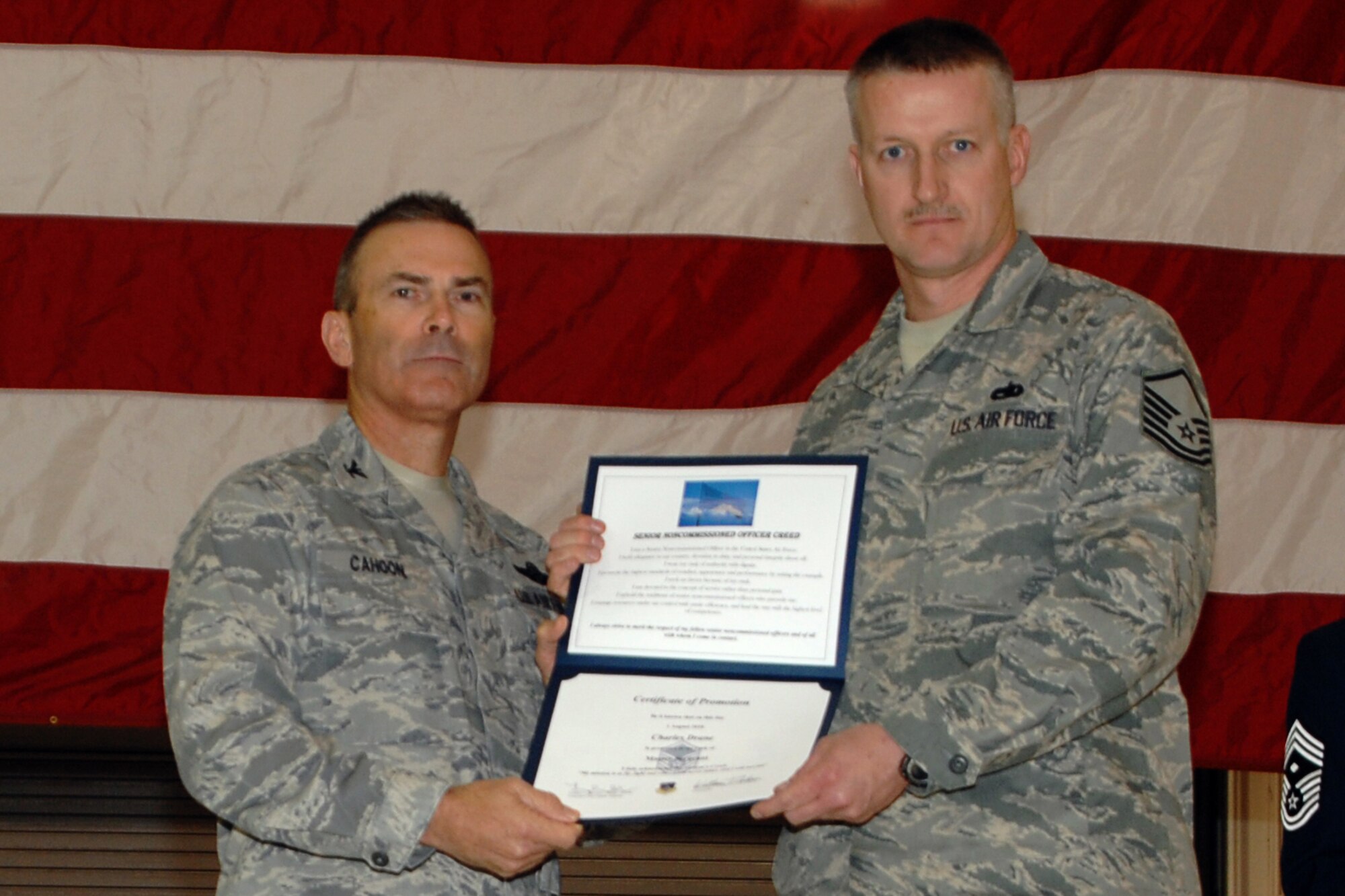 GRISSOM AIR RESERVE BASE, Ind. -- Col. William T. "Tim" Cahoon and Master Sgt. Charles Drane pose for a photo as Sergeant Drane is inducted into the ranks of senior noncommissioned officers during a special ceremony held here during the November unit training assembly. Sergeant Drane, a KC-135R Stratotanker crew chief with the 434t Aircraft Maintenance Squadron, along with two other Grissom Airmen were recognized for their promotions to master sergeant during the ceremony. Colonel Cahoon is the 434th Air Refueling Wing commander. (U.S. Air Force photo/Senior Airman Carl Berry)
