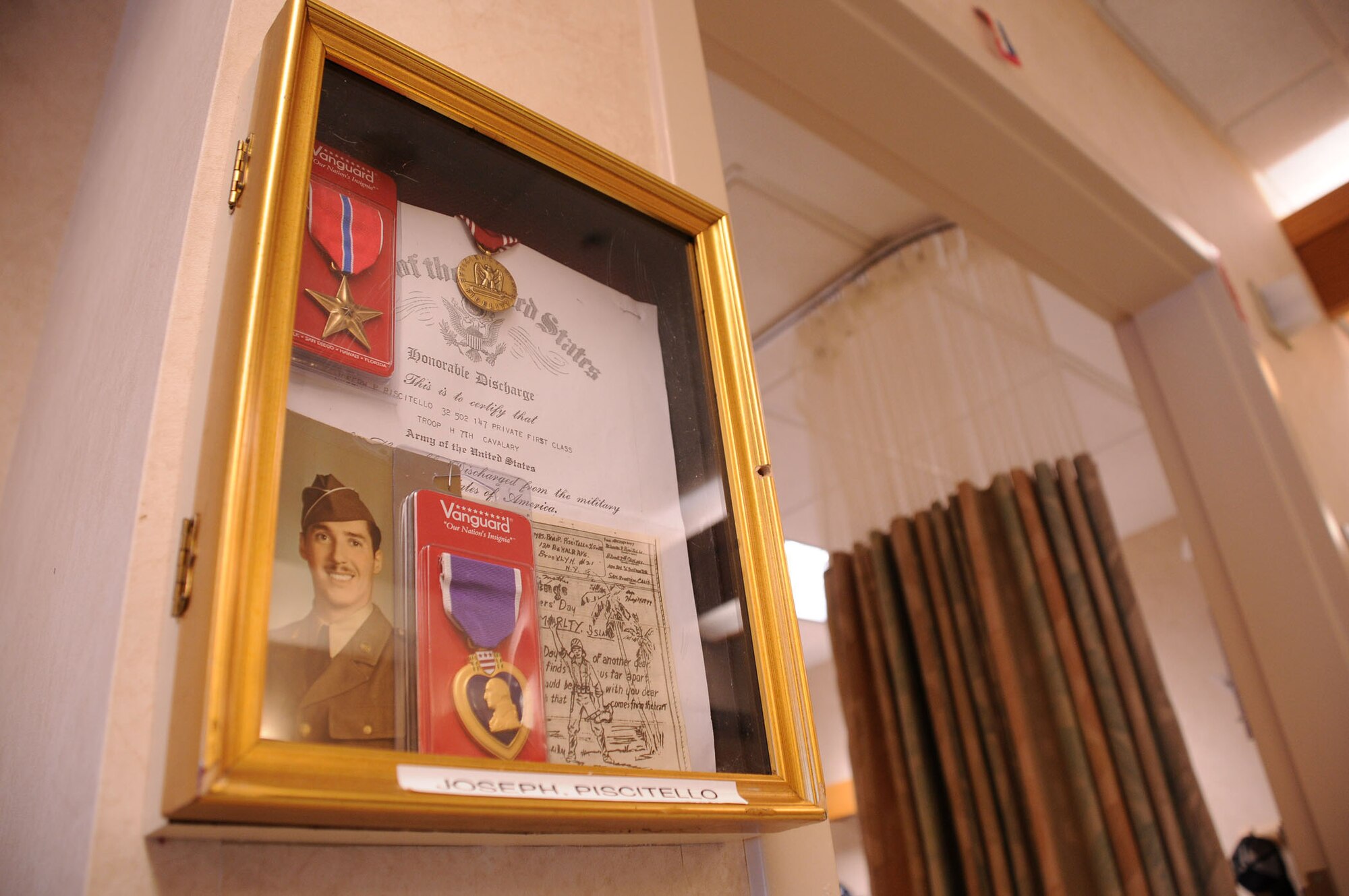 MacDill Air Force Base, Fla. -- For many veterans at the Baldomero State Veteran's Home, life can be very confusing.  Approximately 70 of the 120 veterans suffer from Alzheimer's disease.  These veterans often have trouble remembering which room is theirs.  To help with this, members of Operation partnership have constructed and installed shadow boxes like these with photos of the veterans when they were younger, complete with military awards.  Many believe this simple display helps those veterans suffering from memory loss. (Official United States Air Force photo by Staff Sgt. Shawn C. Rhodes)