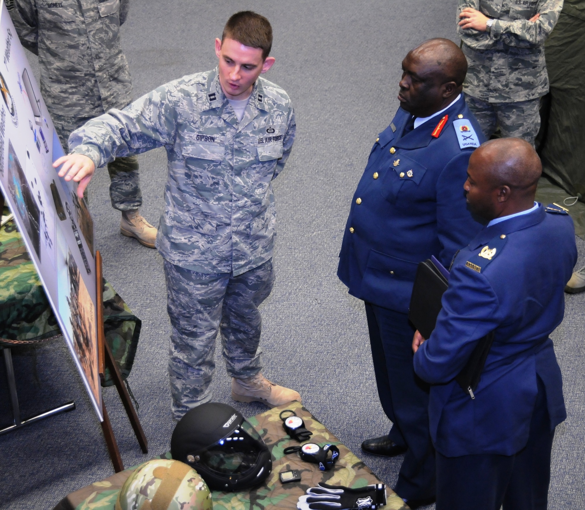 (Left to right) Capt Jeffrey Gipson of the 7th Weather Squadron demonstrates weather equipment used in contingency environments to Ugandan People’s Defence Air Force Chief Maj. Gen. Jim Owoyesigire and Deputy Operations Coordinator Maj Chris Kasaija during a visit by the Ugandan Air Chief to 17th Air Force (Air Forces Africa) and Team Ramstein Nov. 10. The Ugandan Airmen’s visit, which also included the 86th Airlift and 435th Air Ground Operations Wings in addition to the 52nd Fighter Wing at Spangdahlem Air Base, focused on cooperation between the UPDAF and 17th AF, the air component for U.S. Africa Command. (USAF photo by Master Sgt. Jim Fisher) 