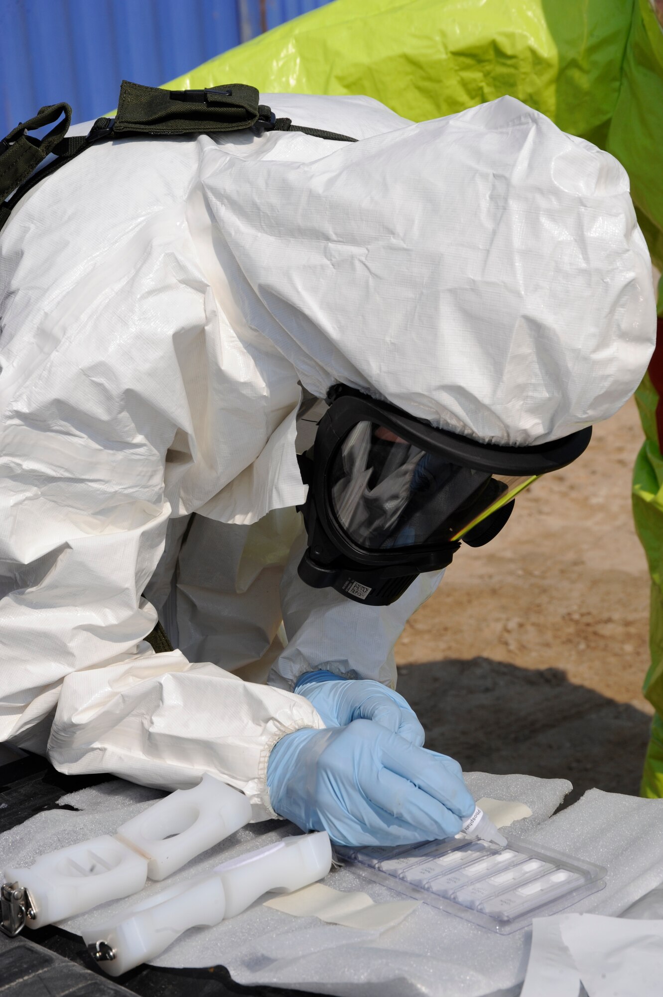 Airman 1st Class Zachary Certain, 380th Expeditionary Civil Engineer Squadron emergency management journeyman, simulates running a hand held assay to test for the presence of biological agents Nov. 13, 2010 during a joint bio environmental/emergency management exercise at an undisclosed location in Southwest Asia. During the exercise Airmen from the 380th ECES and 380th Expeditionary Medical group practiced responding to an unknown hazard, and monitored for chemical, biological and radiological hazards. The Airmen were tested on use of the equipment and their knowledge the readings they were receiving. (U.S. Air Force photo/ Tech. Sgt. April Wickes)