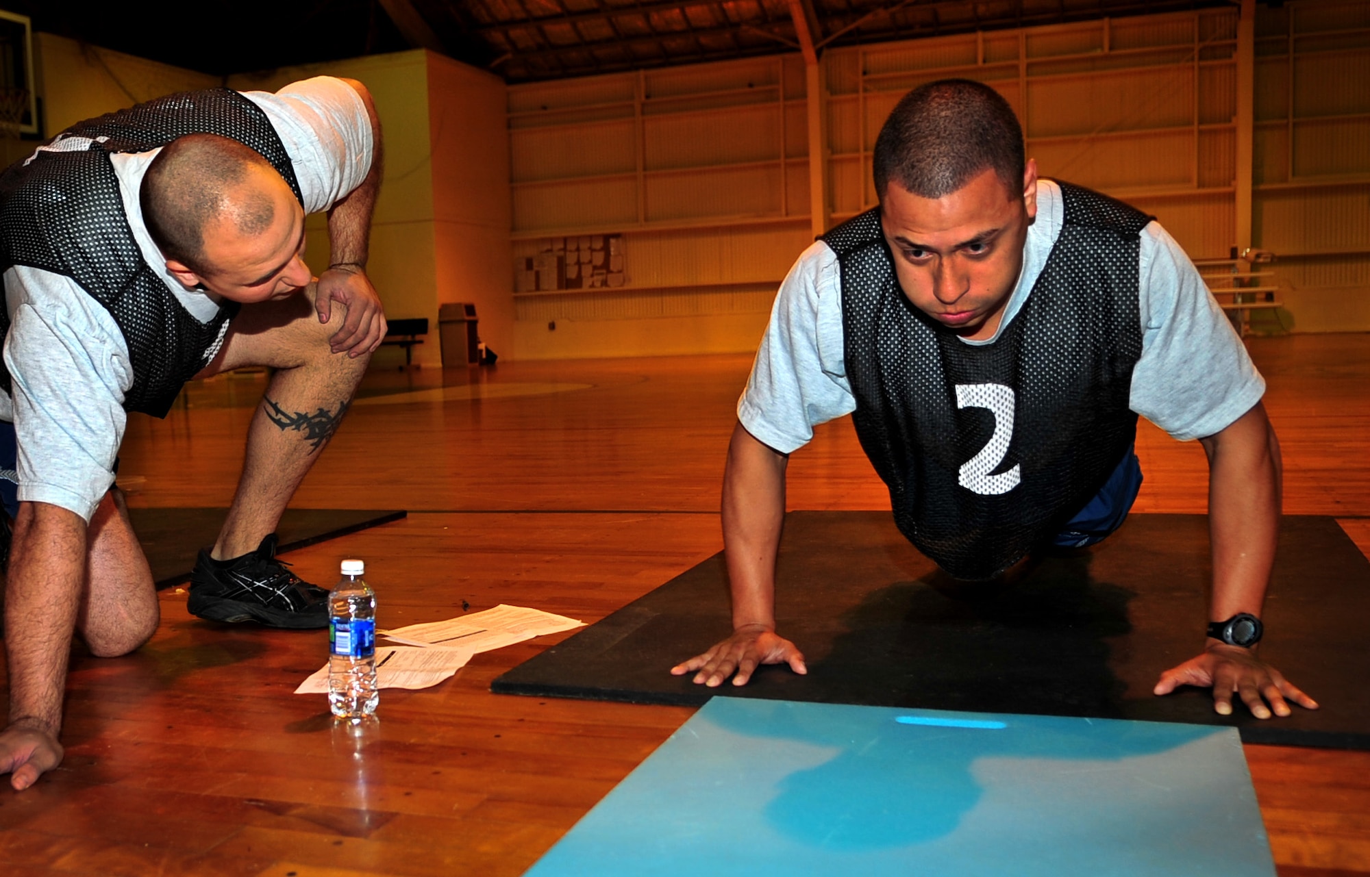 A Kadena Airman concentrates on breathing during the push-up portion of a PT test at the O’Conner Gym Nov. 12. Up to 40 Airmen are tested during each official testing session. For men under 30 years old, the minimum number of push-ups is 33, and for women under 30, the minimum is 18. (U.S. Air Force photo/ Airman 1st Class Tara A. Williamson)