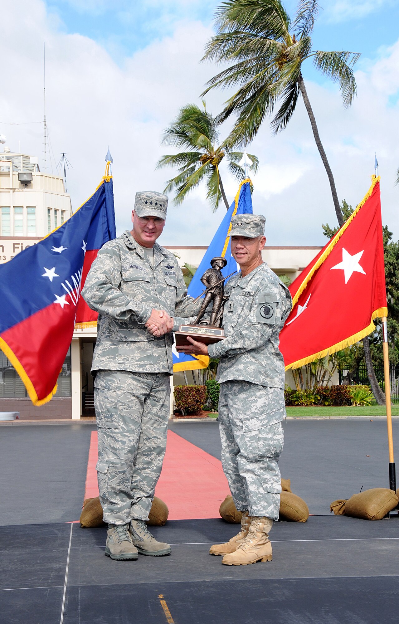 Gen. Craig T. McKinley, National Guard Bureau chief, awards Maj. Gen. Robert G. F. Lee, adjutant general Hawaii, the National Guard's Minuteman award during Gen. Lee's farewell ceremony on Joint Base Pearl Harbor-Hickam, Nov. 6. (U.S. Air Force photo/Tech. Sgt. Betty J. Squatrito-Martin)