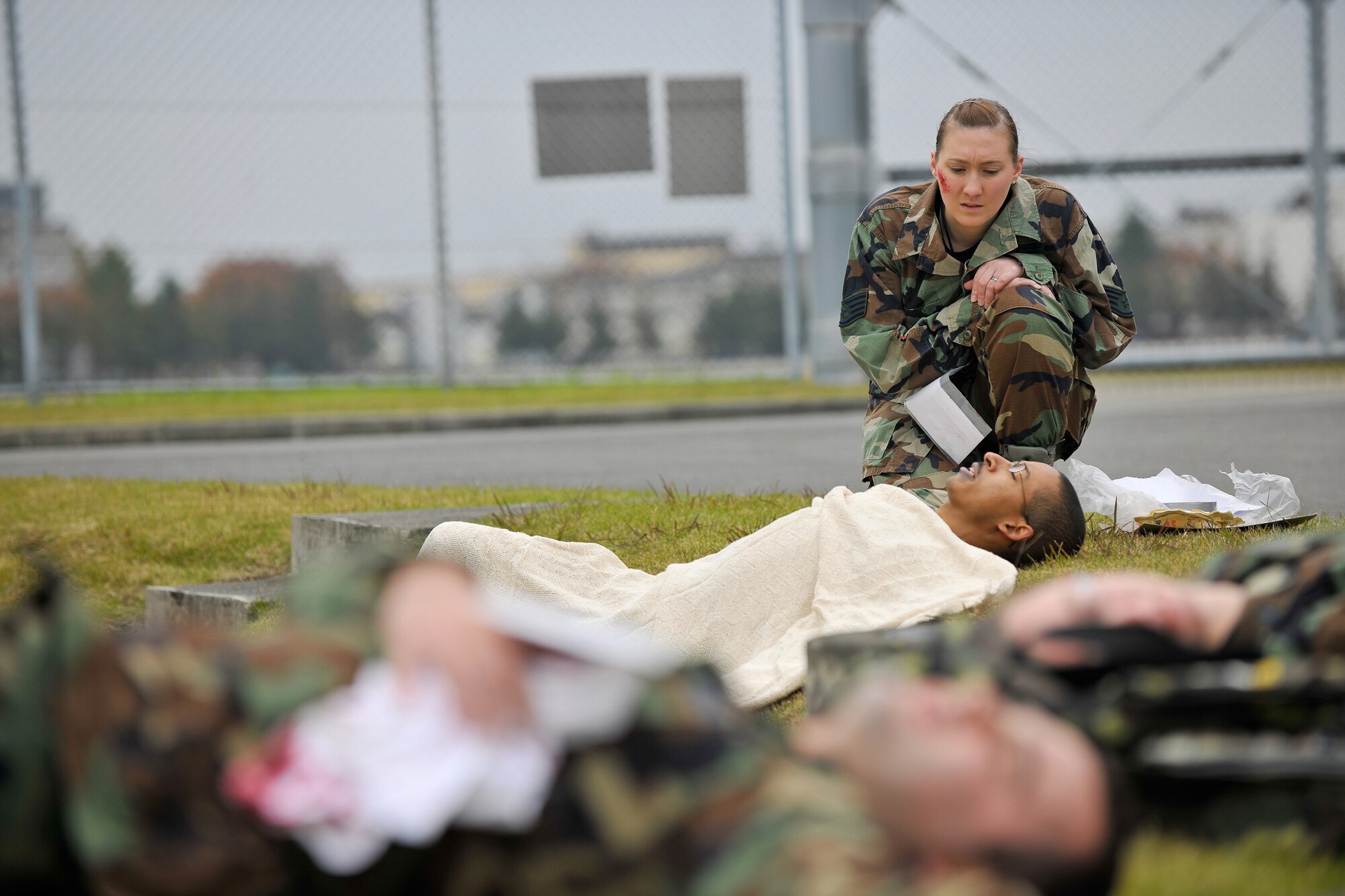 YOKOTA AIR BASE, Japan -- Senior Airman Joanne Higgins, 374th Maintenance Squadron observes a simulated mortar attack victim after she immobilized him here Nov. 17 during Phase 2 of the win's Operational Readiness Exercise.(U.S. Air Force photo/Osakabe Yasuo)