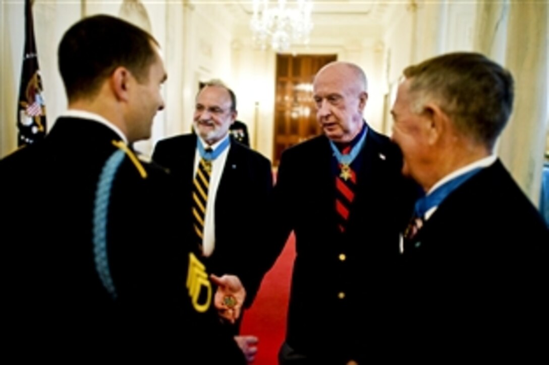 U.S. Army Staff Sgt. Salvatore Giunta meets with three Medal of Honor recipients before he receives the Medal of Honor at the White House in Washington, D.C., Nov. 16, 2010.