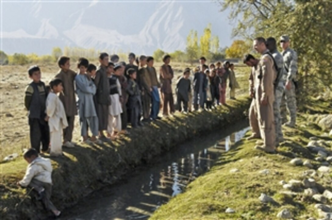 U.S. Air Force airmen greet children during a humanitarian assistance mission in Baharak, Afghanistan, Nov. 11, 2010. The airmen, assigned to the 438th Air Expeditionary Wing, visited the area with other coalition and Afghan forces to support operations aimed at building an orphanage in the area.
