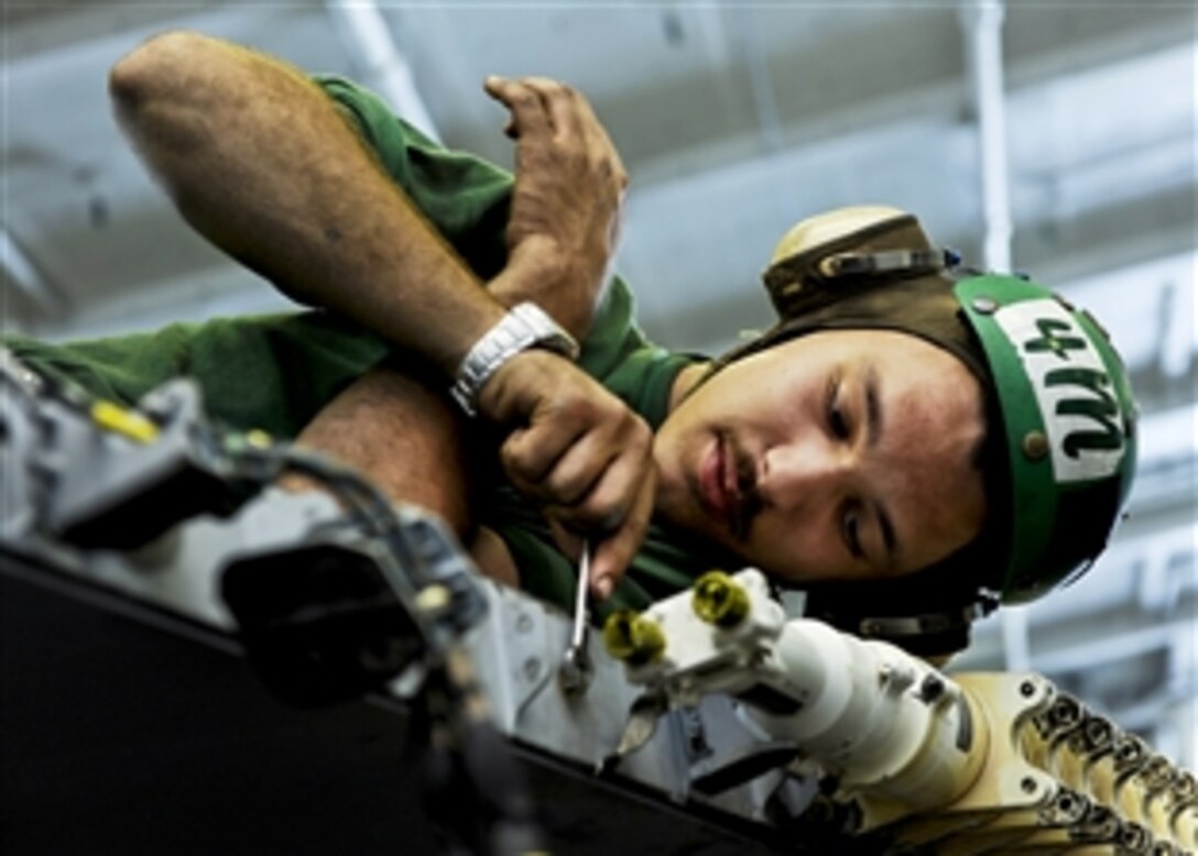 U.S. Navy Seaman Justin Klippert installs a leading edge flap transmission assembly on an F/A-18E Super Hornet in the hangar bay aboard the aircraft carrier USS Harry S. Truman in the Arabian Sea, Nov. 13, 2010. Klippert is an aviation structural mechanic airman.