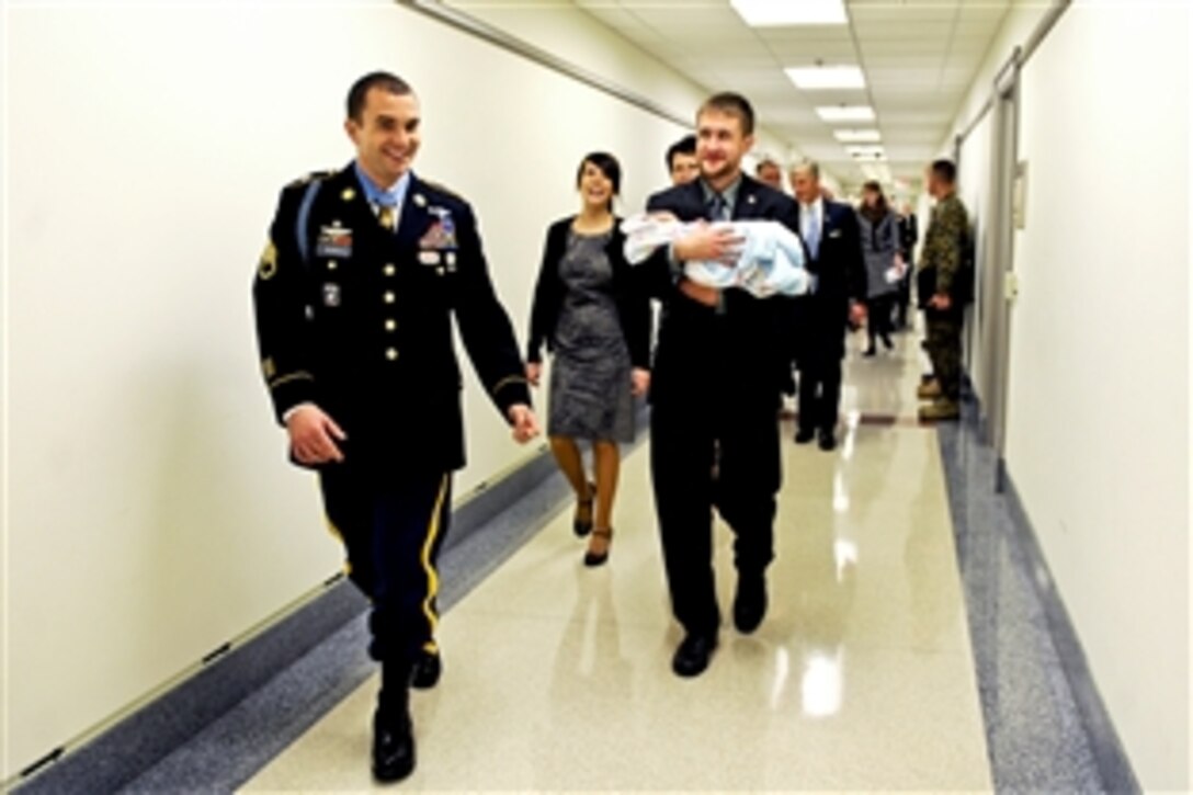 Medal of Honor recipient Army Staff Sgt. Salvatore Giunta shares a laugh with his brother and sister during their visit to the Pentagon, Nov. 17, 2010. 
