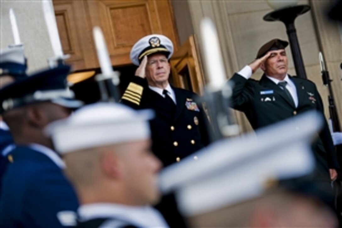 Navy Adm. Mike Mullen, chairman of the Joint Chiefs of Staff, and Israeli Chief of Defense Lt. Gen. Gabi Ashkenazi salute during the playing of their national anthems at a ceremony welcoming Ashkenazi to the Pentagon, Nov. 17, 2010.