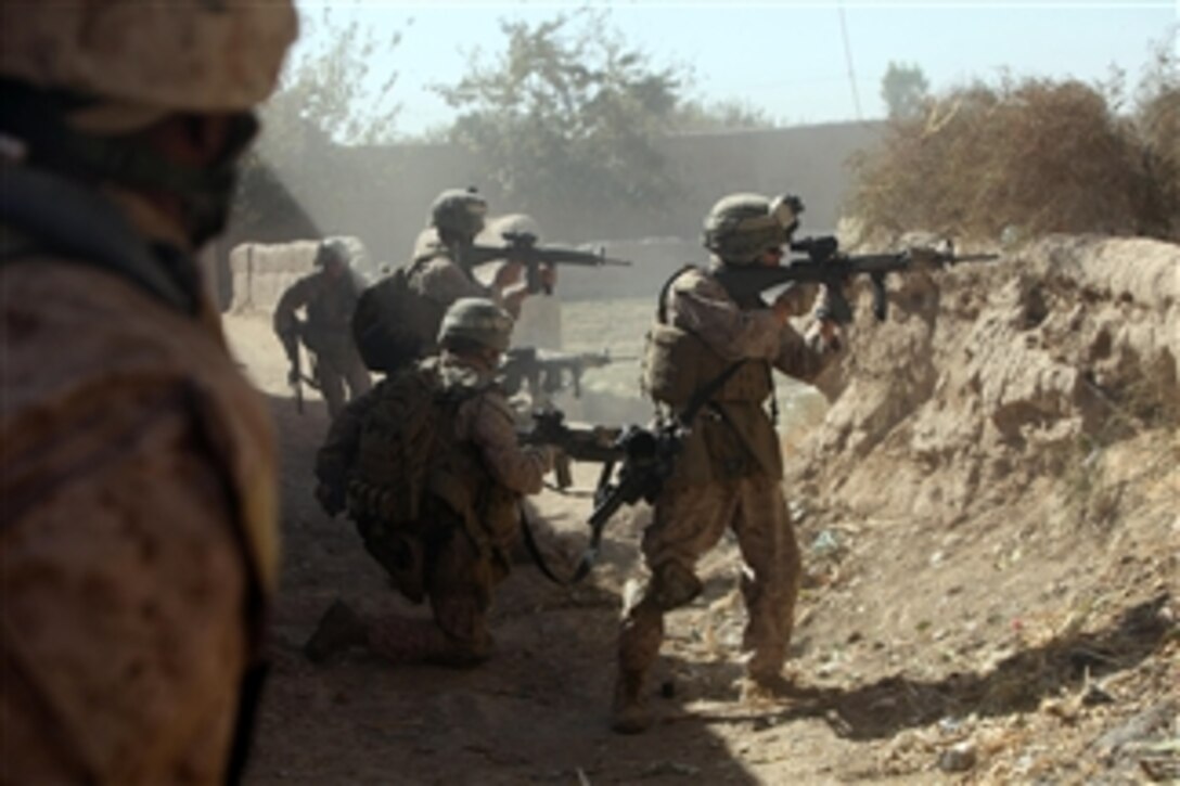 U.S. Marines with India Company, 3rd Battalion, 5th Marine Regiment provide covering fire for fellow Marines as they move out of a danger area after taking sniper fire during a security patrol in Sangin, Afghanistan, on Nov. 2, 2010.  The battalion is one of the combat elements of Regimental Combat Team 2, whose mission is to conduct counterinsurgency operations in partnership with the International Security Assistance Force.  