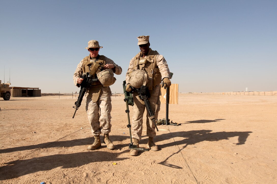 Cpls. Justin Wade and Jeremy White, both Crash Fire Rescue Marines with Marine Wing Support Squadron 373, 3rd Marine Aircraft Wing (Forward), complete the metal detector test lane during the practical application portion of the Counter IED Class aboard Camp Bastion, Afghanistan.  MWSS-373 Marines receive the training before they can go on convoys with the unit.  During the class, Marines learn about the different types of improvised explosive devices, how they are made and what signs to look for when searching for IEDs.