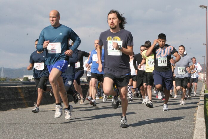 Station residents begin the 5K and 10K run in support of the 35th annual Great American Smokeout on the seawall behind the IronWorks Gym here Nov. 18. Forty runners hit the pavement in support of the event, with Adrian Figueroa posting the best overall 10K time of 42:06.