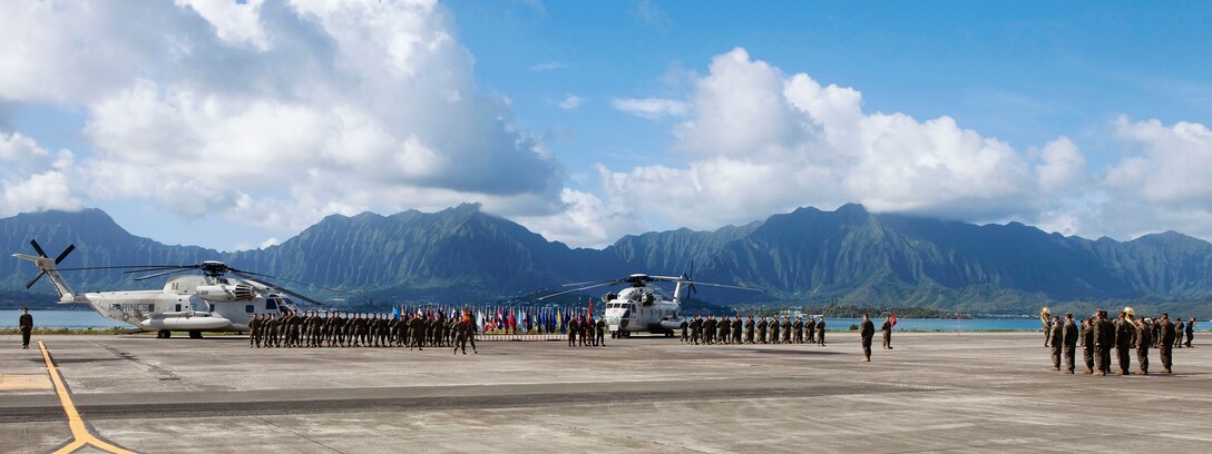 A parade detail comprised of Marines from Marine Heavy Helicopter Squadron 363 stands by for the commencement of the squadron’s change of command ceremony at Marine Corps Air Station Kaneohe Bay, Hawaii, Nov. 17, 2010. During the ceremony, Lt. Col. James Dobes, outgoing commanding officer, HMH-363, relinquished command to Lt. Col. Mark Revor, incoming commanding officer, HMH-363. Revor was previously assigned to the headquarters of Marine Aircraft Group 24 and has served as the operations officer and executive officer for HMH-363.::r::::n::