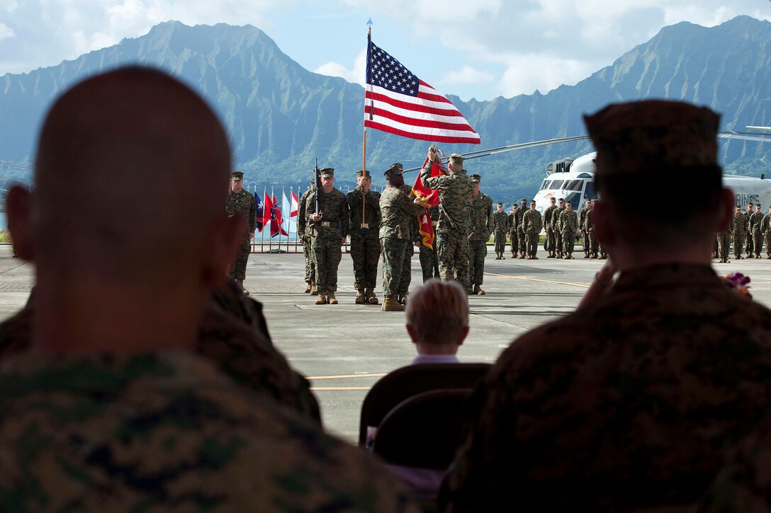 Sgt. Maj. Mitchell Green, squadron sergeant major, Marine Heavy Helicopter Squadron 363, holds the squadron battle colors as Lt. Col. James Dobes, outgoing commanding officer, HMH-363, decorates them with the Afghanistan Campaign Streamer with bronze star during a change of command ceremony at Marine Corps Air Station Kaneohe Bay, Hawaii, Nov. 17, 2010. After performing duties as HMH-363’s commanding officer since March 2009, Dobes relinquished command to Lt. Col. Mark Revor, who was previously assigned to the headquarters of Marine Aircraft Group 24 and has served as the operations officer and executive officer for HMH-363.