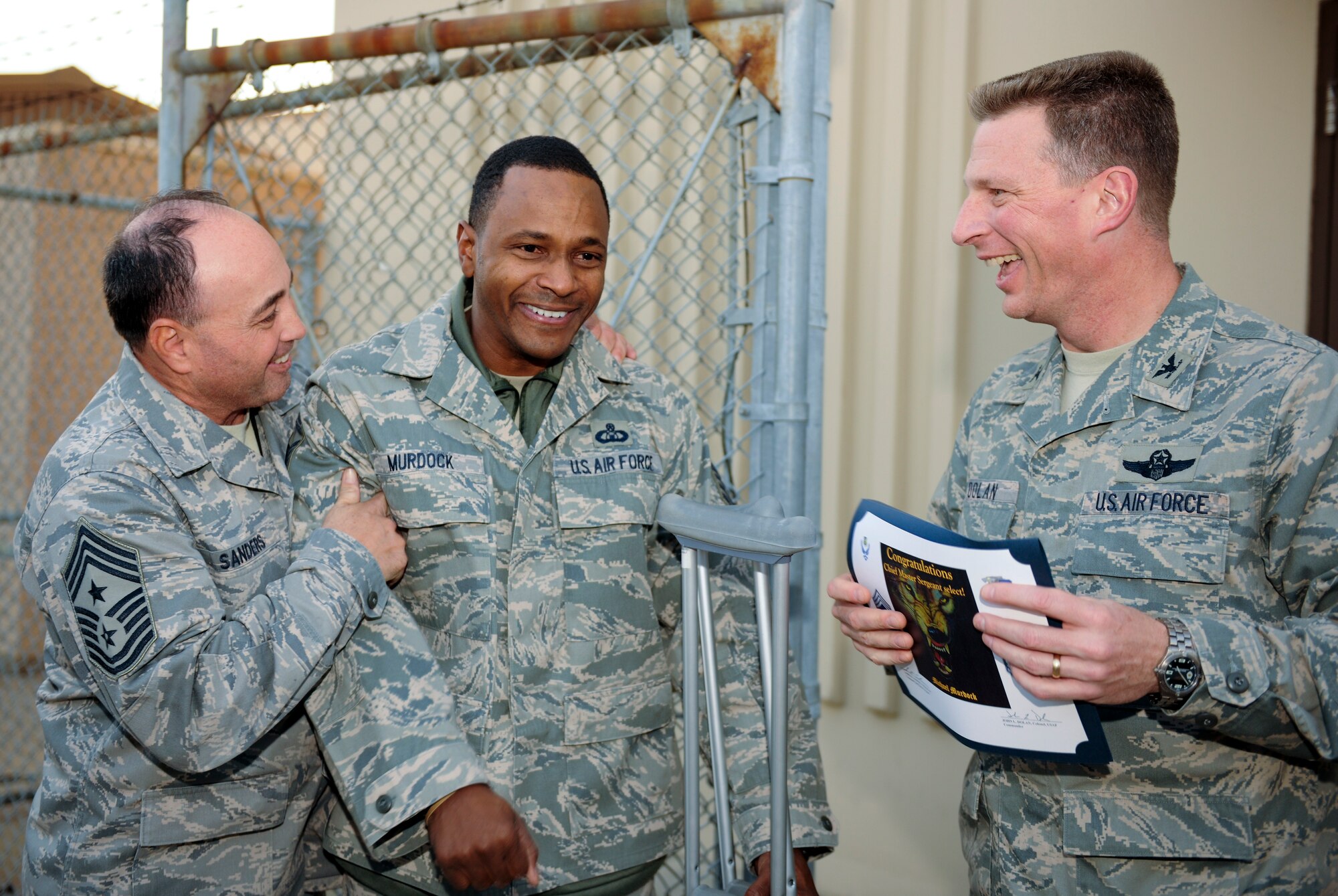 KUNSAN AIR BASE, Republic of Korea -- Chief Master Sgt. James Sanders, 8th Fighter Wing command chief, and Col. John Dolan, 8th Fighter Wing commander, congratulate Senior Master Sgt. Michael Murdock, 8th Operations Support Squadron, on his selection to chief master sergeant Nov. 18. (U.S. Air Force photo/Staff Sgt. Jonathan Pomeroy)