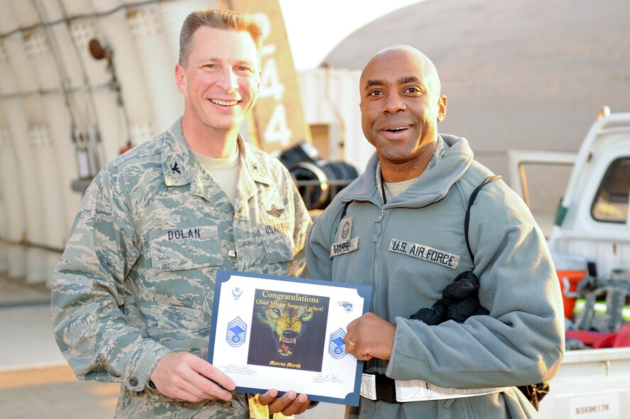 KUNSAN AIR BASE, Republic of Korea -- Col. John Dolan, 8th Fighter Wing commander, congratulates Senior Master Sgt. Marcus Marsh, 8th Aircraft Maintenance Squadron, on his selection to chief master sergeant Nov. 18. (U.S. Air Force photo/Staff Sgt. Jonathan Pomeroy)