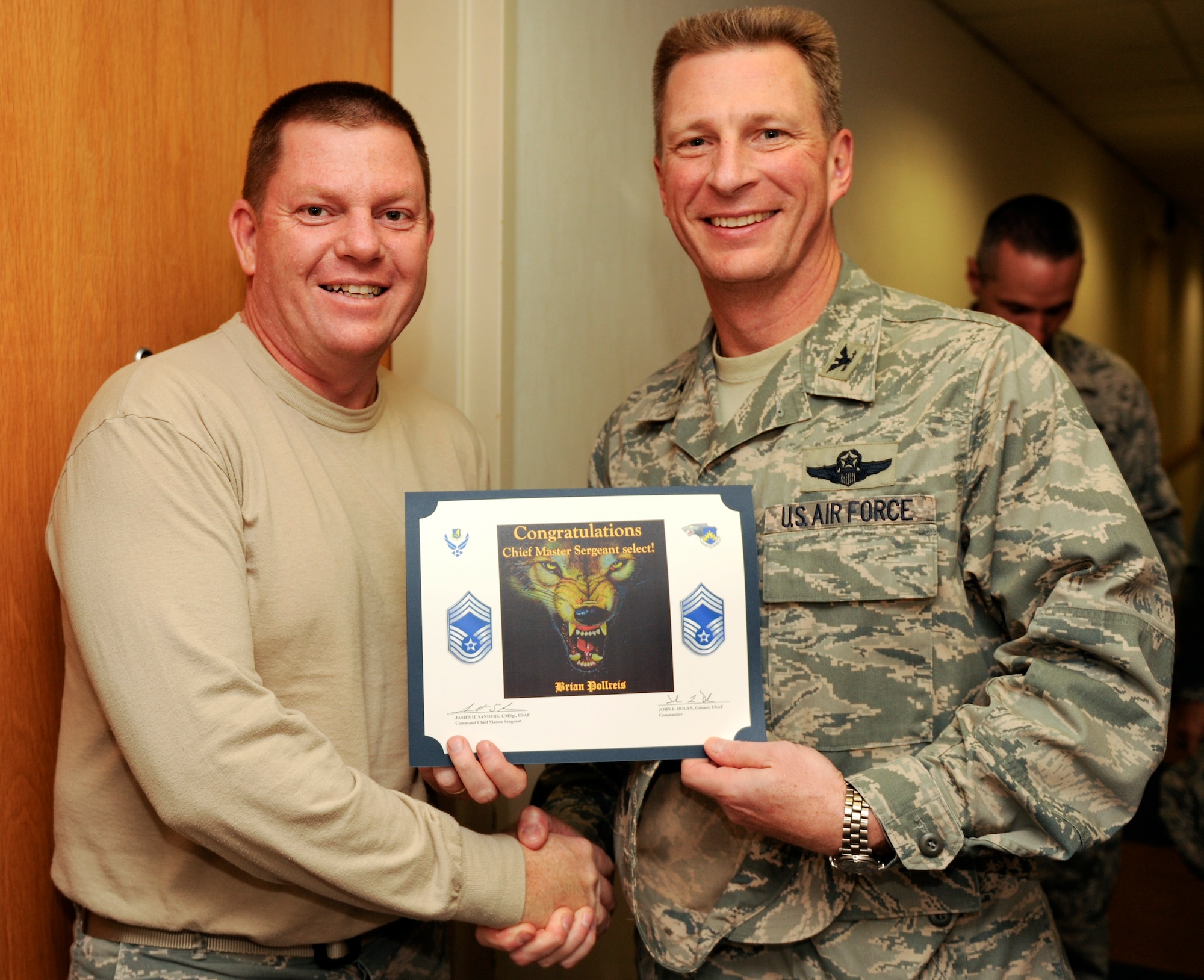 KUNSAN AIR BASE, Republic of Korea -- Col. John Dolan, 8th Fighter Wing commander, congratulates Senior Master Sgt. Brian Pollreis, 8th Maintenance Squadron, on his selection to chief master sergeant Nov. 18. (U.S. Air Force photo/Staff Sgt. Jonathan Pomeroy)
