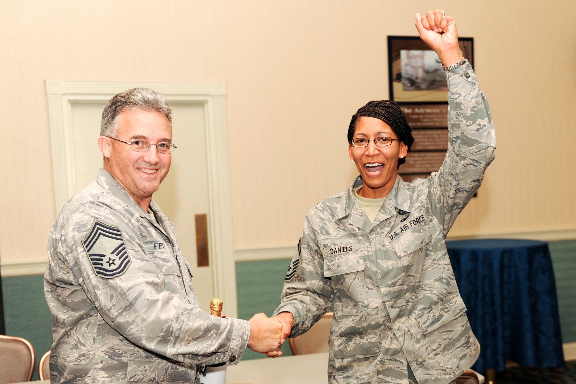 KUNSAN AIR BASE, Republic of Korea -- Chief Master Sgt. Steven Ferrell, president of the Kunsan Chief's Group, congratulates Senior Master Sgt. Christine Daniels, 8th Comptroller Squadron, on her selection to chief master sergeant Nov. 18. (U.S. Air Force photo/Staff Sgt. Jonathan Pomeroy)