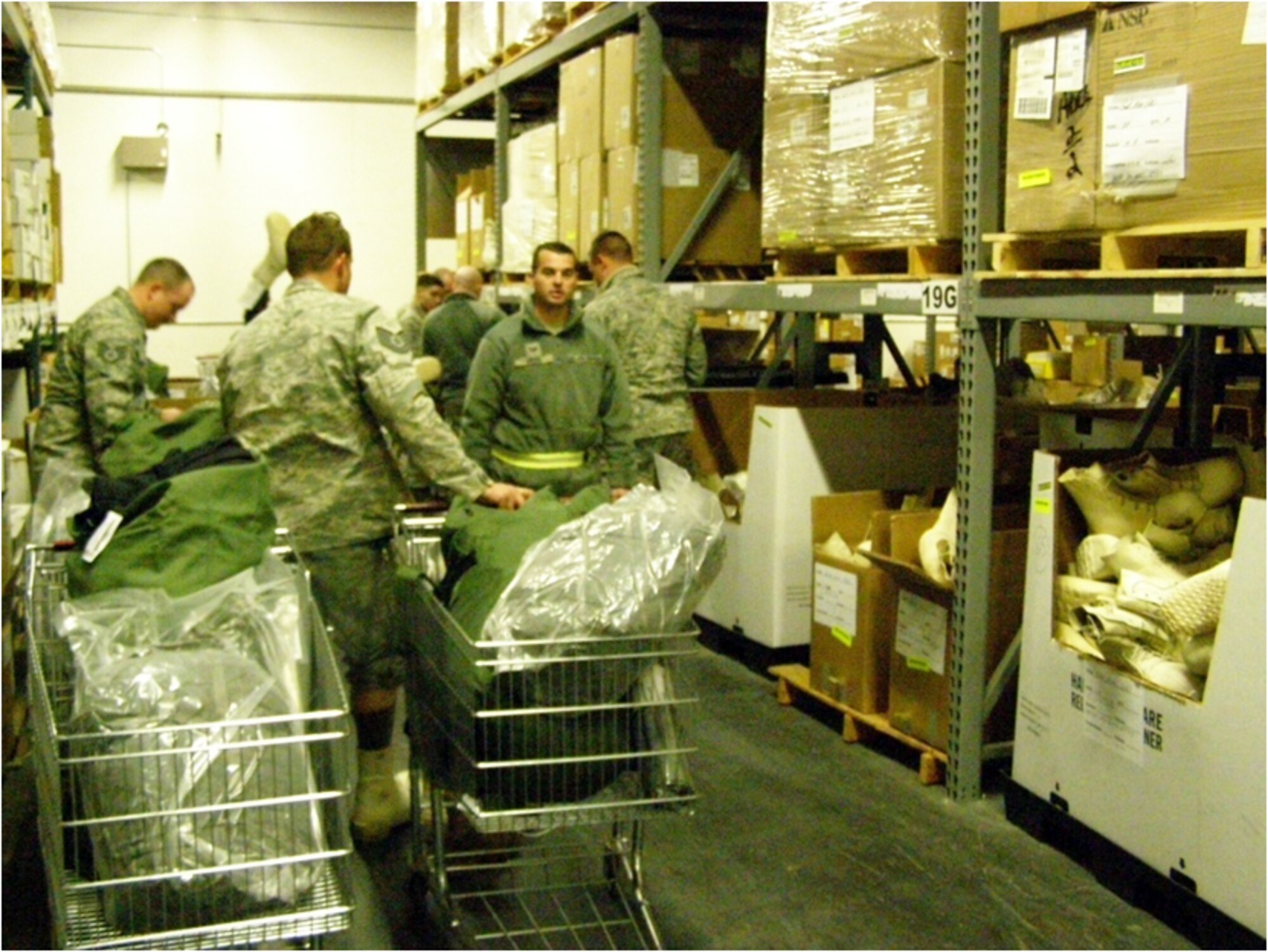 F-22 Aircraft Recovery Operation Ground Support, 18 November 2010, JOINT BASE ELMENDORF-RICHARDSON, Alaska. Airmen trying on cold weather boots for proper fit.  (U.S. Air Force courtesy photo)
