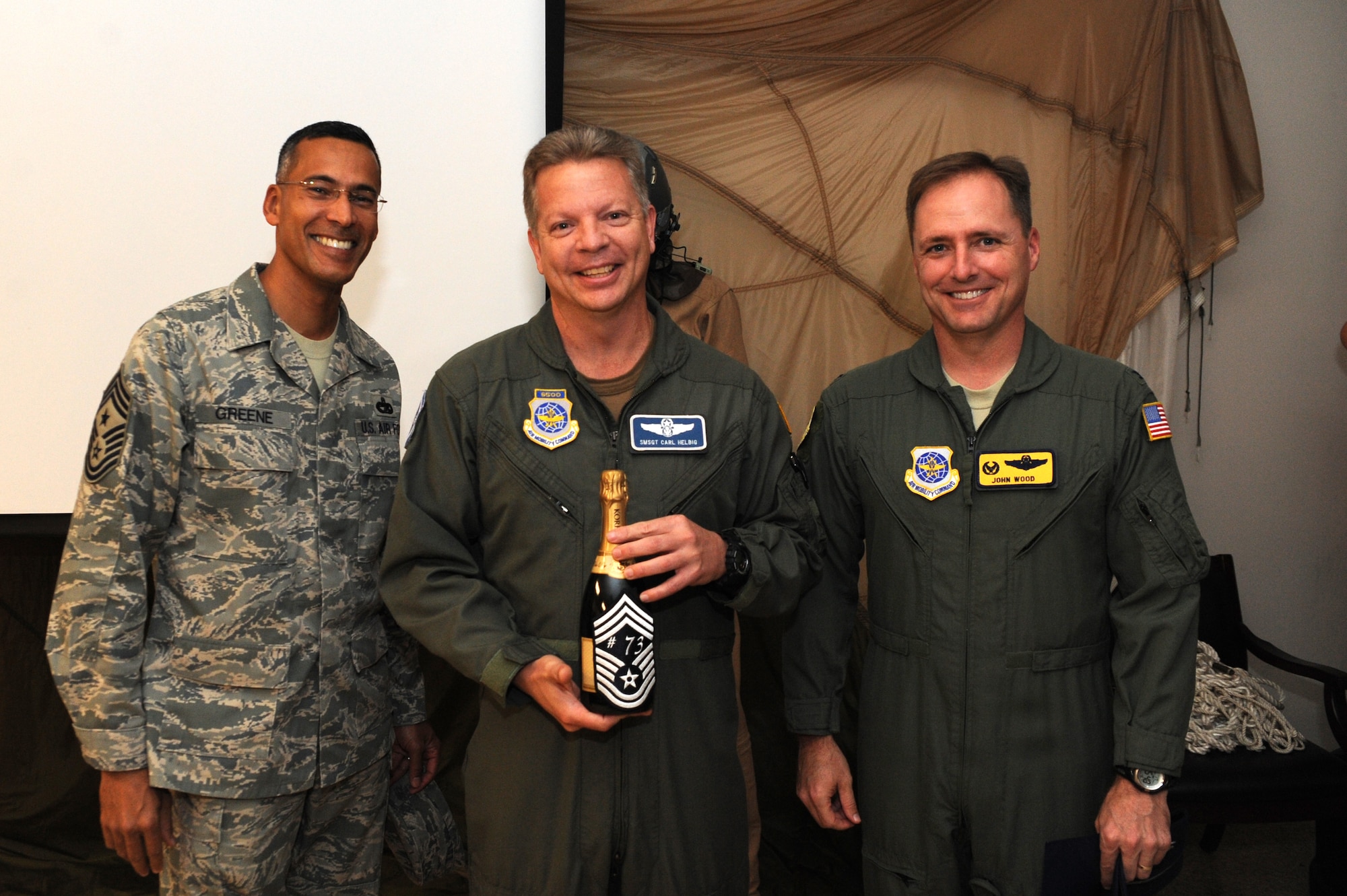 U.S. Air Force Col. John Wood, right, and Chief Master Sgt. Terrence Greene, left, congratulate Senior Master Sgt. Carl Helbig after he was notified of his selection for promotion Nov. 17, 2010, at Joint Base Charleston, S.C. Sergeant Cornell was one of six senior master sergeants selected for promotion from the 437th Airlift Wing. Colonel Wood is the 437 AW commander, and Chief Greene is the 437 AW command chief. Sergeant Helbig is the 17th Airlift Squadron superintendent. (U.S. Air Force photo/James M. Bowman)