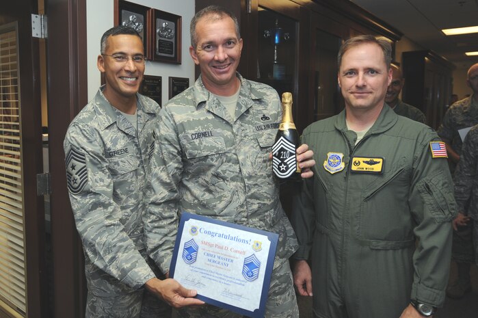 U.S. Air Force Col. John Wood, right, and Chief Master Sgt. Terrence Greene, left, congratulate Senior Master Sgt. Paul Cornell after he was notified of his selection for promotion Nov. 17, 2010, at Joint Base Charleston, S.C. Sergeant Cornell was one of six senior master sergeants selected for promotion from the 437th Airlift Wing. Colonel Wood is the 437 AW commander, and Chief Greene is the 437 AW command chief. Sergeant Cornell is the 437th Maintenance Squadron first sergeant. (U.S. Air Force photo/James M. Bowman)