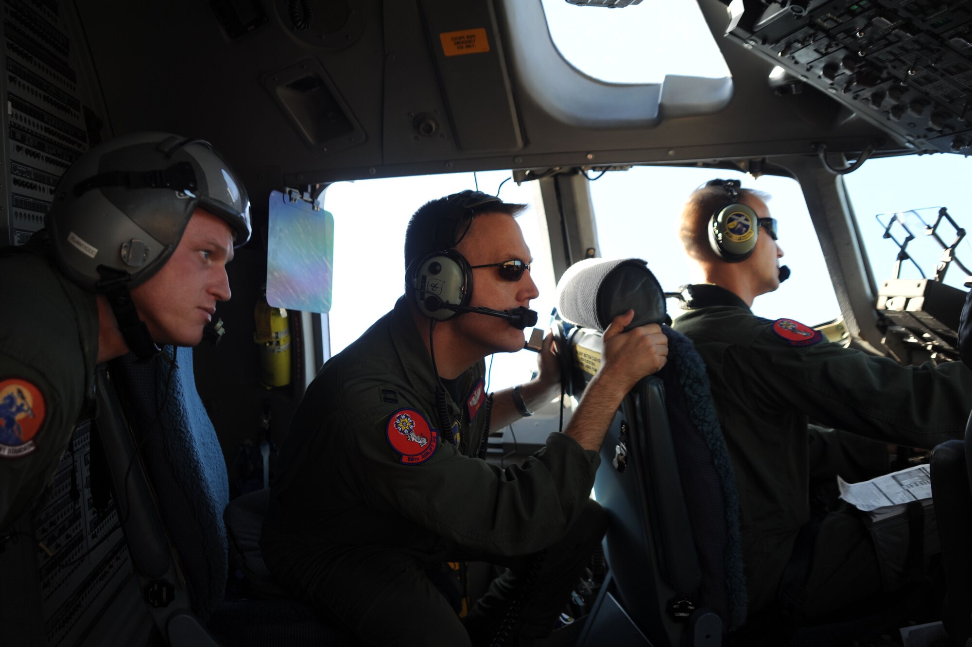 ALTUS AIR FORCE BASE, Okla. - U.S. Air Force Tech. Sgt. Chad Turner (left), Capt. Bryan Bailey, 58th Airlift Squadron (middle) and Capt. Ryan Goodlin 58th Airlift Squadron (right) search for simulated surface-to-air missles during a Mobility Air Force Exercise Nov 18.  The MAFEX is a bi-annual Air Force-wide training opportunity hosted by the Air Force Weapons School at Nellis AFB, Nevada. (U.S. Air Force photo by Airman 1st Class Myles Stepp / Released 97th Air Mobility Wing Public Affairs)