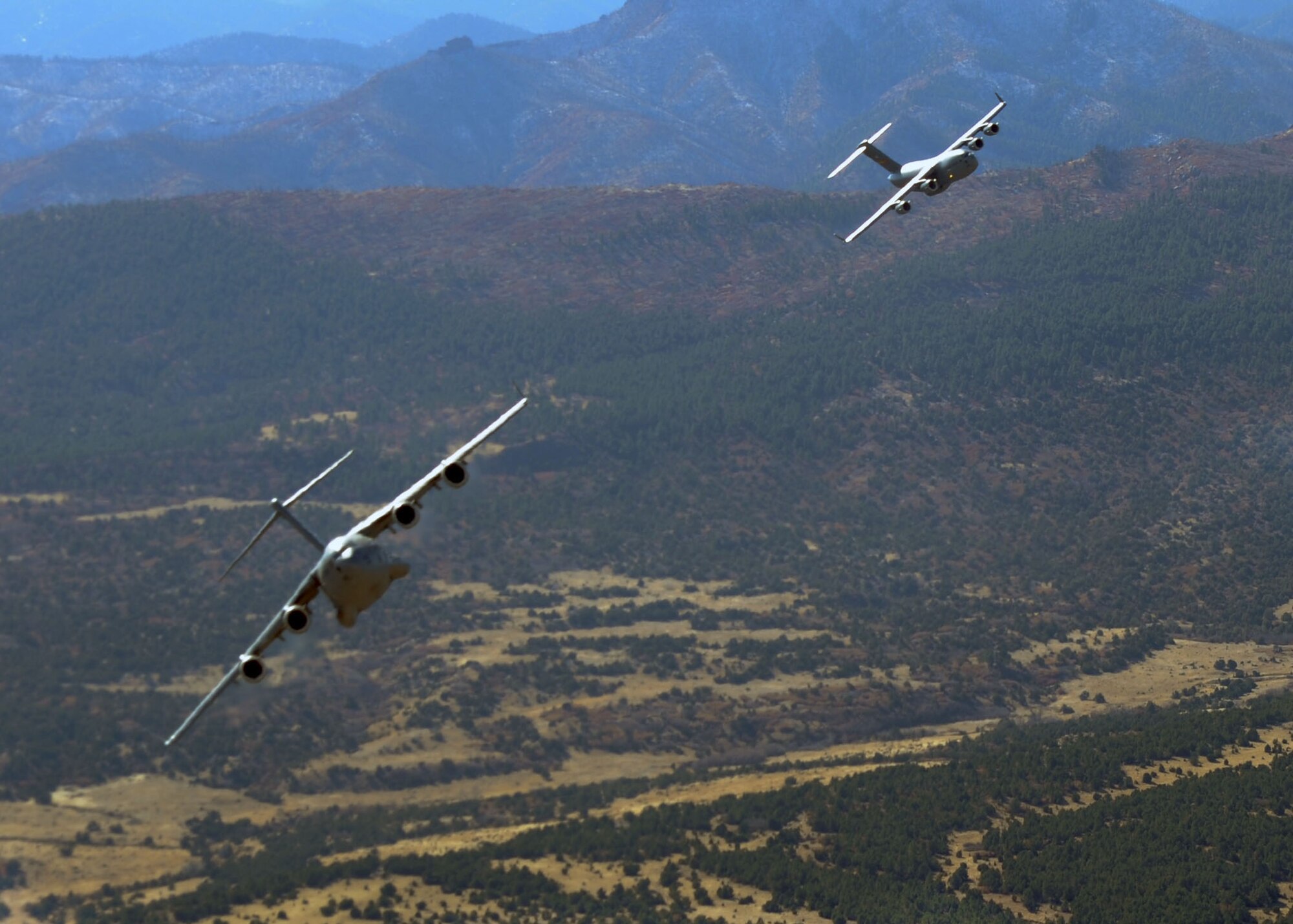 ALTUS AIR FORCE BASE, Okla. - Two C-17 Globemaster III move into formation during a Mobility Air Force Exercise Nov. 17. The MAFEX is a biannual Air Force-wide training opportunity hosted by the Air Force Weapons School at Nellis AFB, Nev. (U.S. Air Force photo by Airman 1st Class Myles Stepp / 97th Air Mobility Wing Public Affairs)
