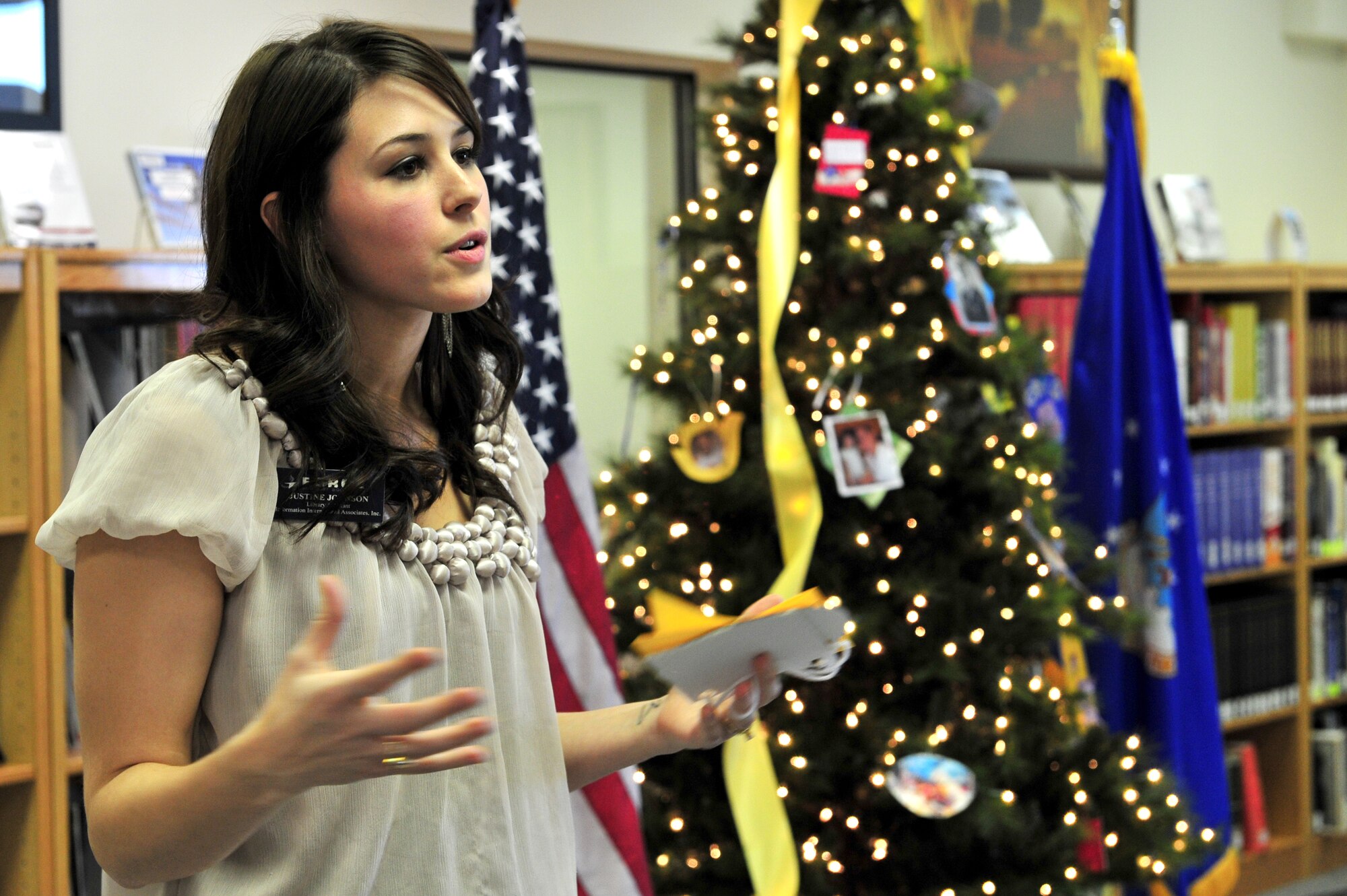 Library staff member, Mrs. Justine Johnson begins a Heroes' Tree Dedication ceremony at the base library, Nov. 14, 2010. Our Heroes' Tree is a community outreach program co-founded in 2005 by Stephanie Pickup, author of The Soldiers' Tree, and Marlene Lee, author of The Hero in My Pocket. This program promotes awareness of the service and sacrifice of U.S. service members and their families. (U.S. Air Force photo by Tech Sgt. Josef Cole)(RELEASED) 