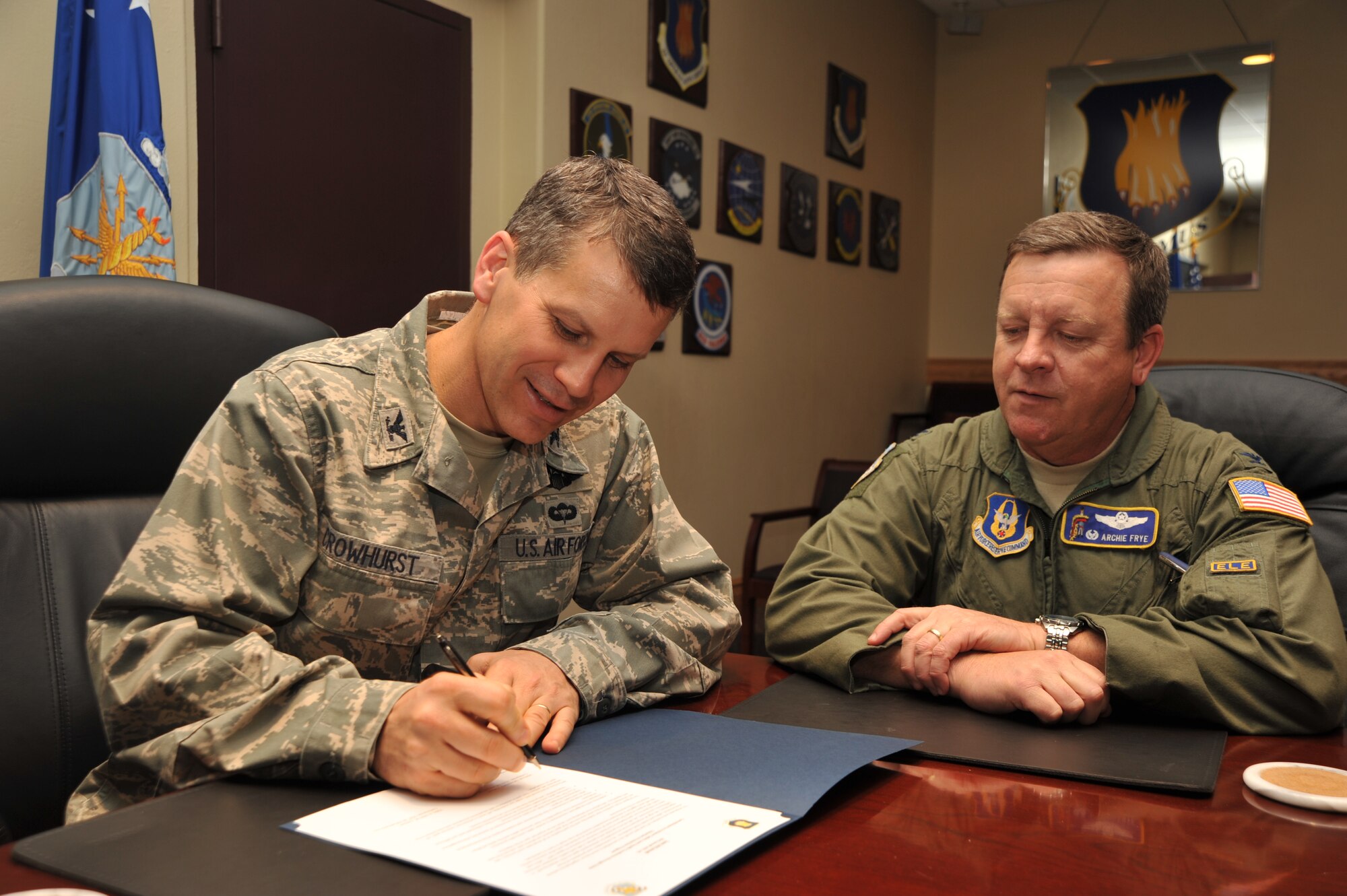 (Left to right) Col. Jamie Crowhurst, 22nd Air Refueling Wing commander, and Col. Edsel A. “Archie” Frye Jr., 931st Air Refueling Group Commander, sign the Voluntary Protection Program Commitment Letter, Nov. 17, 2010, McConnell Air Force Base, Kan.  The VPP is an Occupational Safety and Health Administration program that aims to bring mishap levels down in the Air Force.  (U.S. Air Force photo/Senior Airman Abigail Klein) 