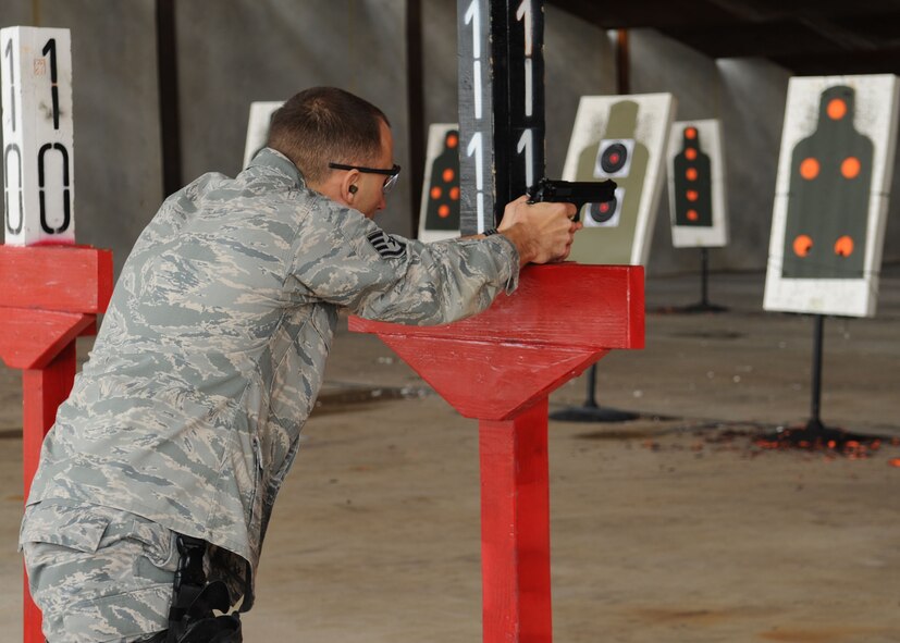 Staff Sgt. Jacob Lacefield, 28th Security Forces Squadron patrolman, Ellsworth Air Force Base, S.D., fires his 9mm handgun during the Global Strike Challenge Nov. 16 at Barksdale AFB, La. The GSC involves approximately 400 participants from five Air Force Global Strike Command wings as well as participants from Air Combat Command, the Reserves and the Air National Guard. (U.S. Air Force photo/Airman 1st Class Sean Martin)(Released)
