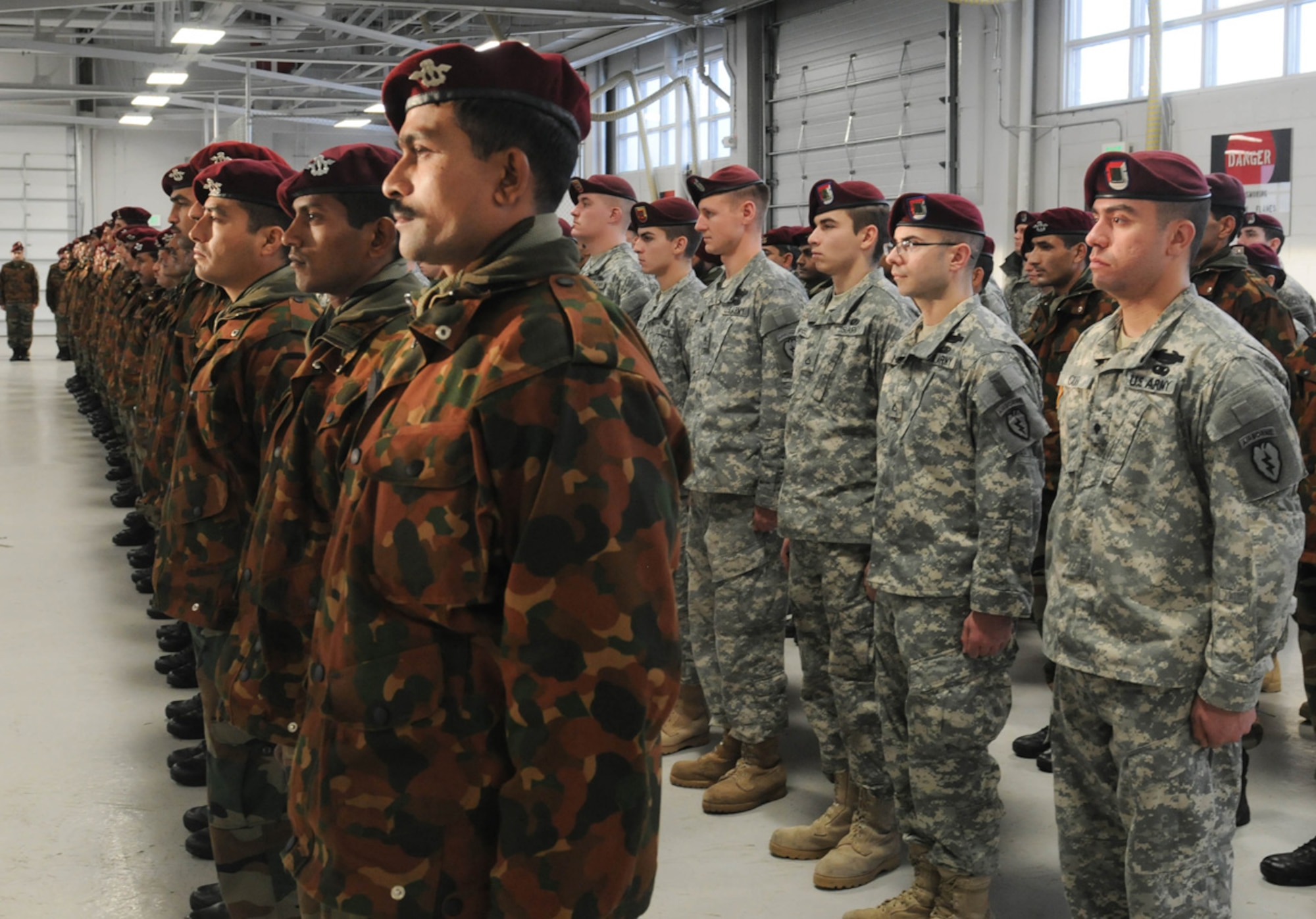 Soldiers of U.S. Army Alaska and the Indian army stand ready to receive foreign airborne jump wings during a wing exchange ceremony Nov. 13 at Joint Base Elmendorf-Richardson, Alaska. The Soldiers earned their foreign jump wings Nov. 10 when they conducted a combined jump during exercise Yudh Abhyas 2010. (U.S. Army photo/Spc. Ashley Armstrong)