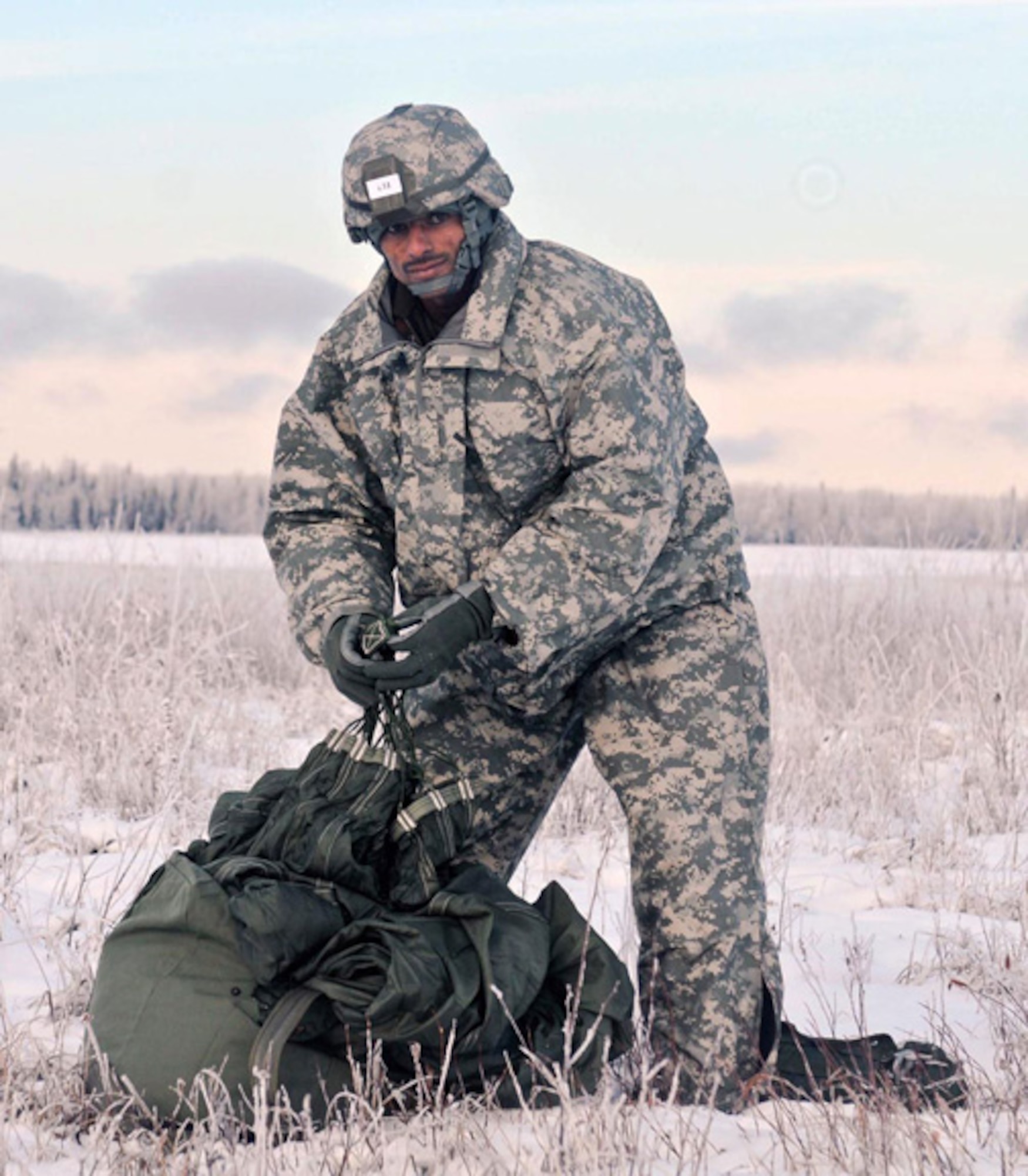 An Indian army soldier packs up his parachute and looks for the turn in point at Malamute drop zone on Joint Base Elmendorf-Richardson after an airborne jump, Nov. 10. About 400 soldiers from U.S. Army Alaska and the Indian army during the combined training exercise Yudh Abhyas 2010. (U.S. Army photo/Spc. Ashley Armstrong)