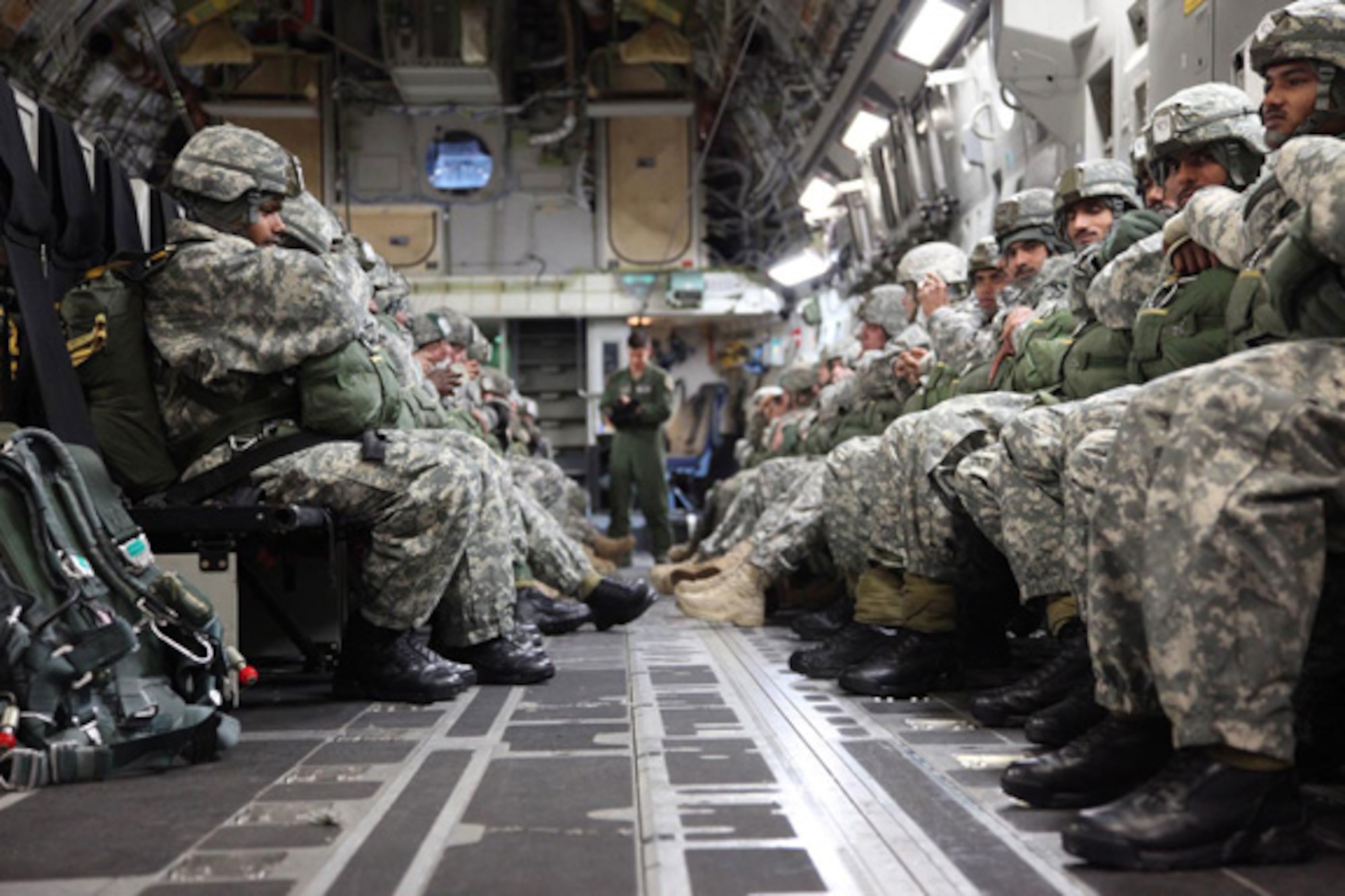 U.S. and Indian army soldiers sit in the back of a C-17 Globemaster III aircraft awaiting commands from jump masters to begin their combined parachute jump, Nov. 10. The jump was part of Yudh Abhyas 2010, an international exercise designed to promote cooperation between the two militaries and hosted by U.S. Army Alaska this year. (U.S. Army photo/Spc. Tiffany Dusterhoft) 