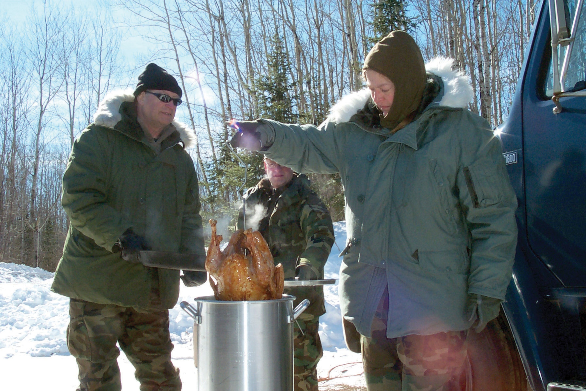 Air Force personnel assigned to the 148th Fighter Wing, Minnesota Air National Guard, cook a deep fried turkey. JBER Fire and Emergency Services recommend not frying turkeys at home. (U.S. Air Force photo/TSgt. Ralph Kaputska)