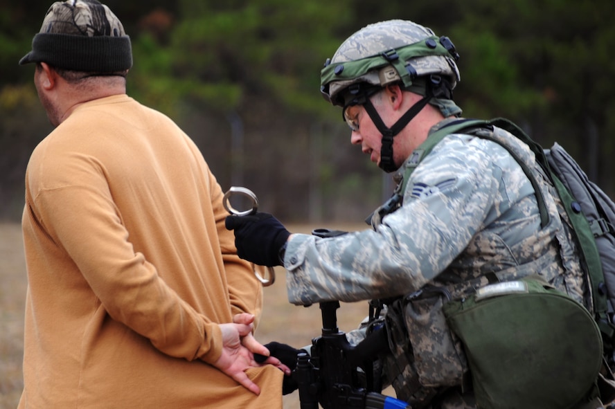 Senior Airman Sean Phelan, 2nd Security Forces Squadron, from Barksdale Air Force Base, La.,  detains a scenario role player during the tactics portion of the Global Strike Challenge at Camp Minden, La., Nov. 13. More than 400 participants took part in GSC competitions at various locations on base. Teams have the opportunity to display their innovative thinking, teamwork and esprit de corps . (U.S. Air Force photo/Senior Airman Brittany Y. Bateman)(RELEASED)