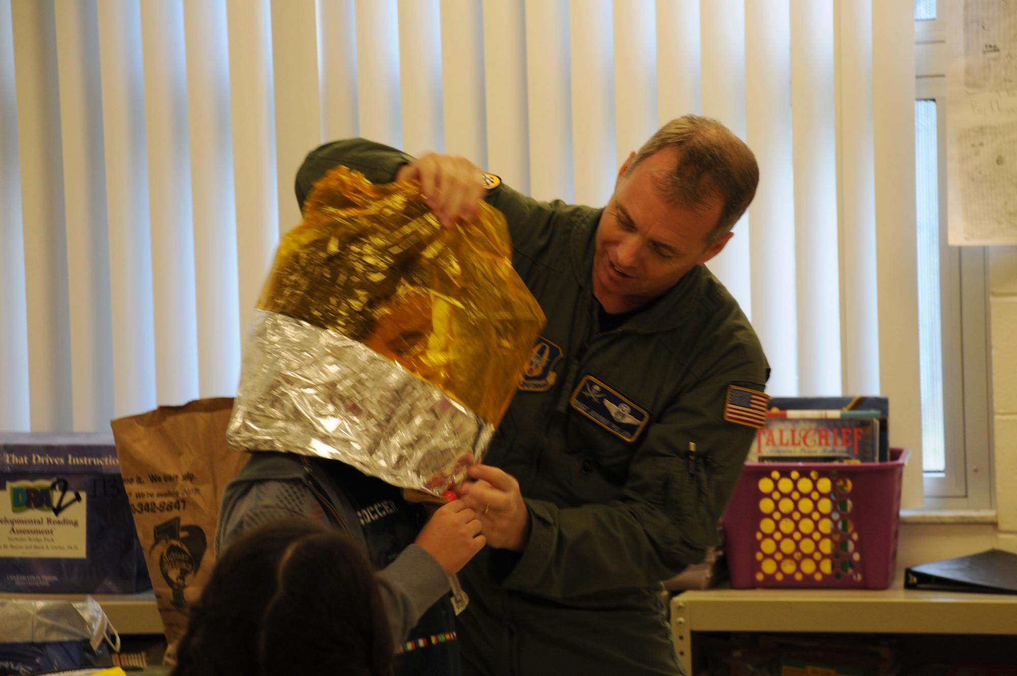 Tampa, Fla. -- Fifth graders recently experienced a taste of life as a boom operator.   Master Sgt. Johnny Pullen, a boom operator with the 927th Air Refueling Wing, demonstrated the oxygen bag that keeps servicemembers alive in a tanker aircraft in case of low oxygen levels.  He visited four classrooms at Crestwood Elementary School, where students learned about the value of science and math as Pullen described his aerial refueling missions, demonstrated life support systems of the aircraft he flies in, and answered questions about life in the military. The students and faculty of schools throughout the Tampa area recently invited servicemembers and other professionals to their schools to present their jobs to students.  (Official Air Force photo by Staff Sgt. Shawn Rhodes)