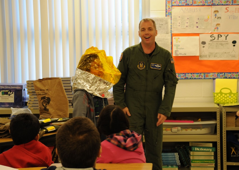 Tampa, Fla. -- Fifth graders recently experienced a taste of life as a boom operator.   Master Sgt. Johnny Pullen, a boom operator with the 927th Air Refueling Wing, demonstrated the oxygen bag that keeps servicemembers alive in a tanker aircraft in case of low oxygen levels.  He visited four classrooms at Crestwood Elementary School, where students learned about the value of science and math as Pullen described his aerial refueling missions, demonstrated life support systems of the aircraft he flies in, and answered questions about life in the military. The students and faculty of schools throughout the Tampa area recently invited servicemembers and other professionals to their schools to present their jobs to students.  (Official Air Force photo by Staff Sgt. Shawn Rhodes)