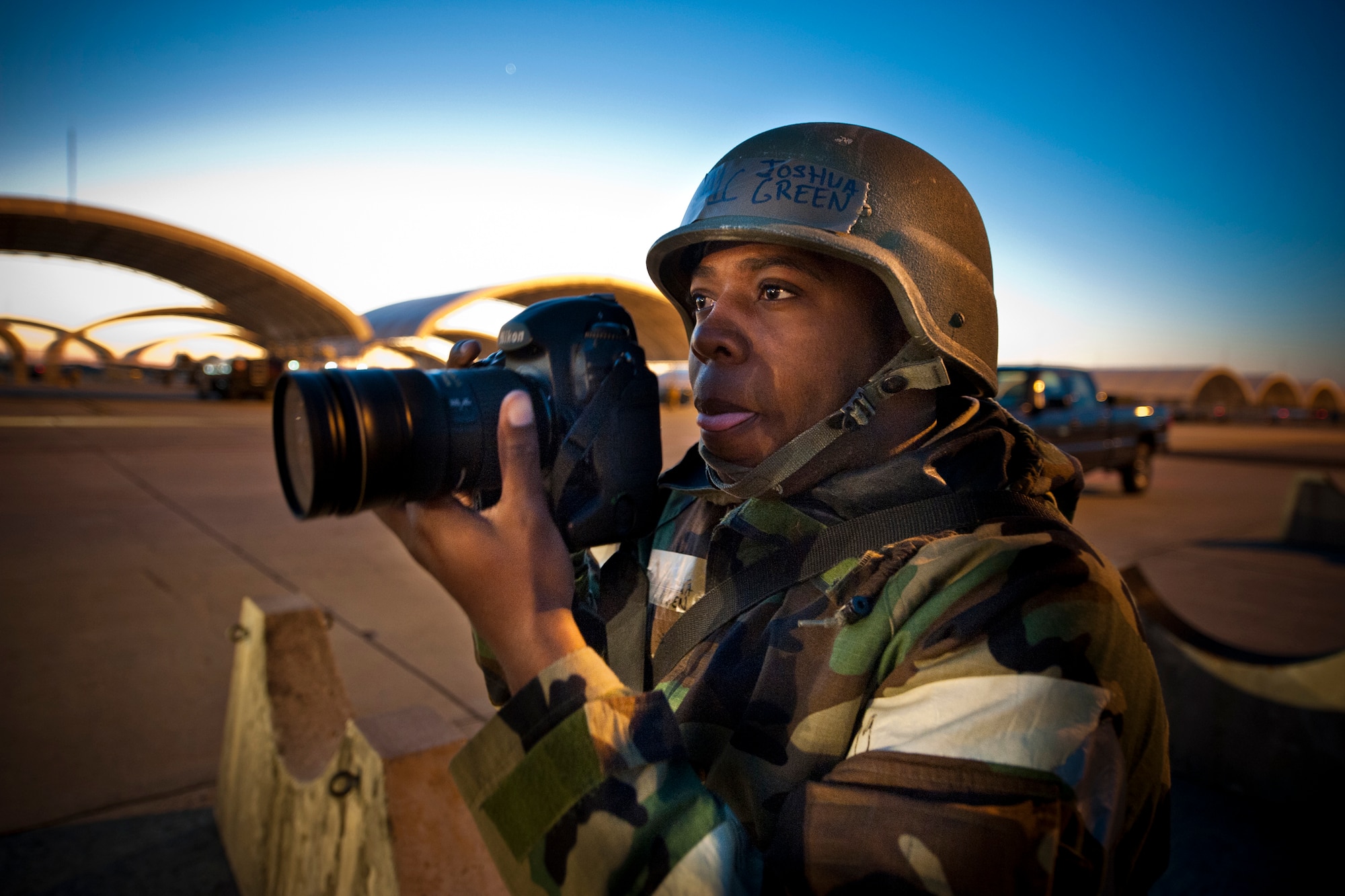 MOODY AIR FORCE BASE, Ga. -- Airman 1st Class, Joshua Green, 23rd Wing public affairs photographer, prepares to capture a photo before beginning his shift during an Phase II Operational Readiness Exercise. This is Airman Green's third time participating in a base-wide exercise. He said he knows the knowledge he learns will stay with him when he deploys. (U.S. Air Force photo/Senior Airman Jamal D. Sutter)(RELEASED)

