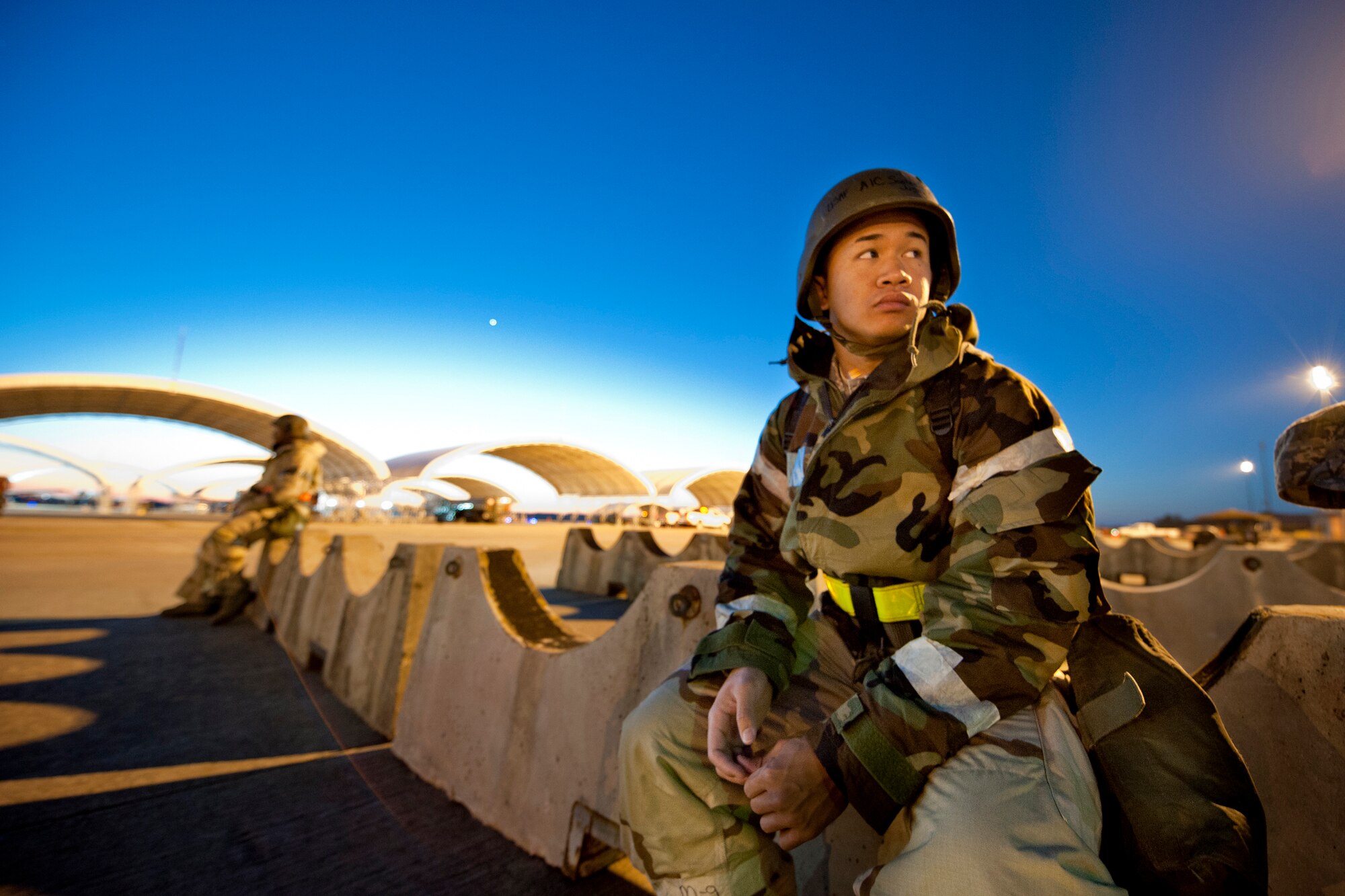 MOODY AIR FORCE BASE, Ga. -- Airman 1st Class Justin Southichack, 23rd Equipment Maintenance Squadron conventional maintenance apprentice, waits  for a transport bus in the early morning of Nov. 17 during a Phase II Operational Readiness Exercise. Buses ran constantly throughout the day to take Airmen to and from their duty locations. (U.S. Air Force photo/Senior Airman Jamal D. Sutter)(RELEASED)