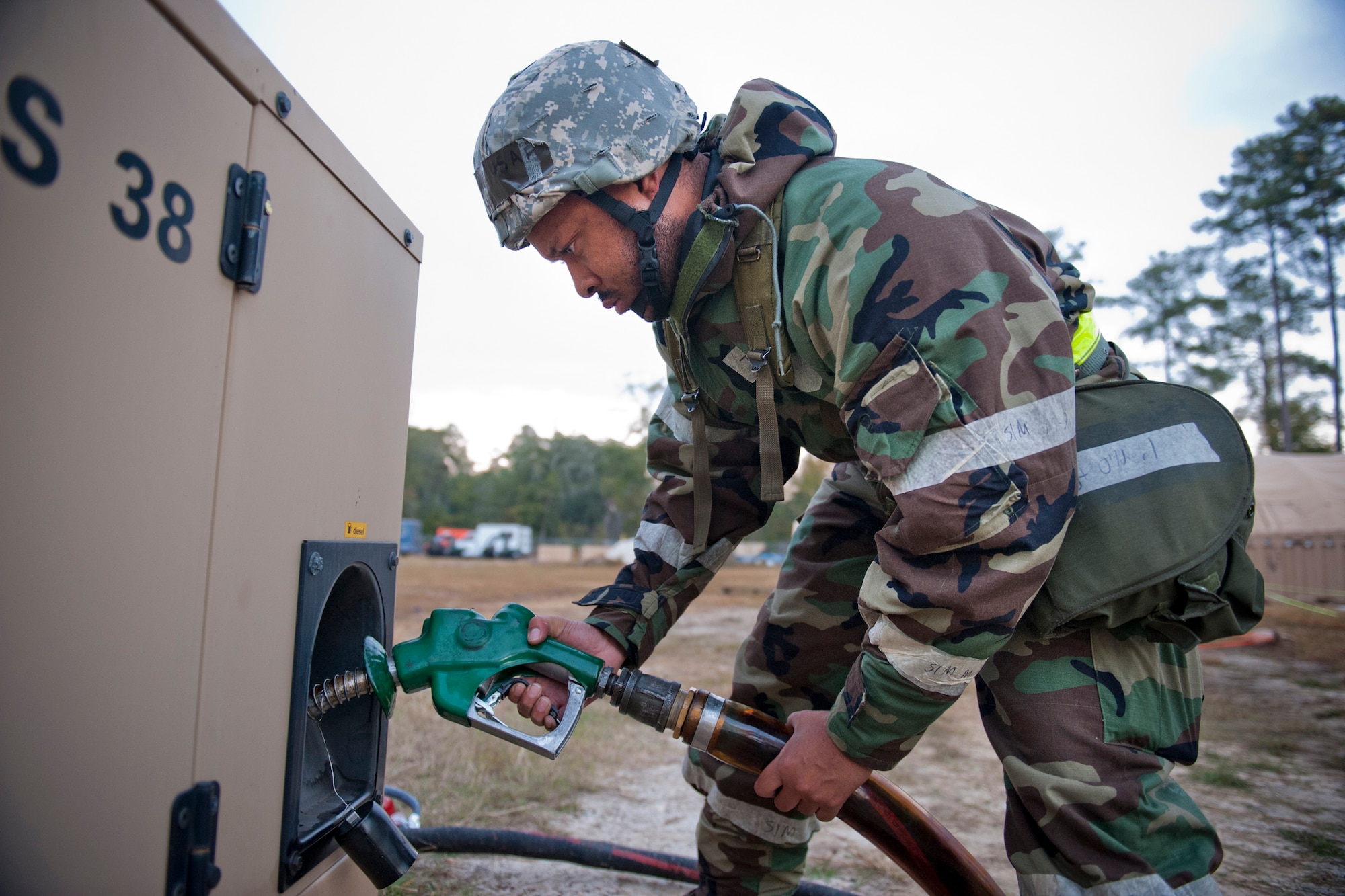 MOODY AIR FORCE BASE, Ga. -- Tech. Sgt. Eric O'Neil, 23rd Civil Engineer Squadron electrical systems journeyman, pumps fuel into a generator during a Phase II Operational Readiness Exercise Nov. 17. Generator maintenance helped to sustain communication and mission effectiveness at the field training exercise site. In addition to maintaining their fuel levels, Airmen checked the site's generators every two hours to monitor power consumption. (U.S. Air Force photo/Senior Airman Jamal D. Sutter)(RELEASED)