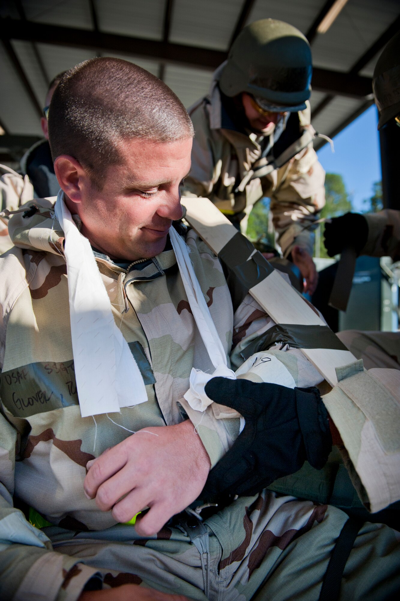 MOODY AIR FORCE BASE, Ga. -- Staff Sgt. Rodney Glover, 23rd Equipment Maintenance Squadron conventional maintenance crew member, watches his co-workers apply a splint to his simulated arm injury during a Phase II Operational Readiness Exercise Nov. 17. The crew members were tasked by an exercise evaluation team member to demonstrate their self-aid and buddy care skills. (U.S. Air Force photo/Senior Airman Jamal D. Sutter)(RELEASED)