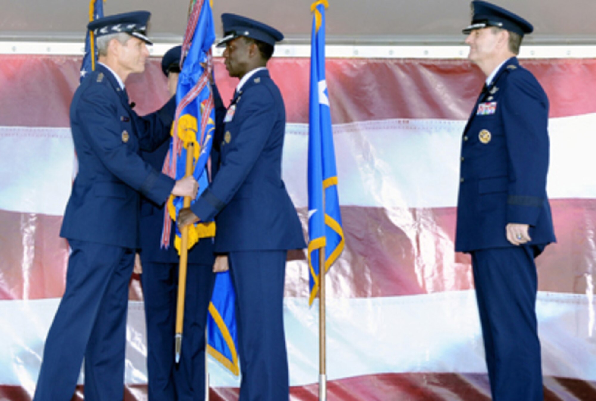 Air Force Chief of Staff Gen. Norton Schwartz (left) presents Gen. Edward A. Rice Jr. (center) with the Air Education and Training Command colors during a change of command ceremony Nov. 17, 2010, at Randolph Air Force Base, Texas. General Rice succeeded Gen. Stephen R. Lorenz (right) as AETC commander. (U.S. Air Force photo/Richard McFadden)
