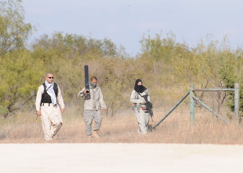 DYESS AIR FORCE BASE, Texas—Dyess Airmen dressed as insurgents walk towards the entry control point at the cantonment area Nov. 15 during an Operational Readiness Exercise here. OREs are conducted to test the capabilities and efficiencies of Airmen to ensure they are prepared for real world events. (U.S Air Force photo/ Airman 1st Class Shannon Hall)  
