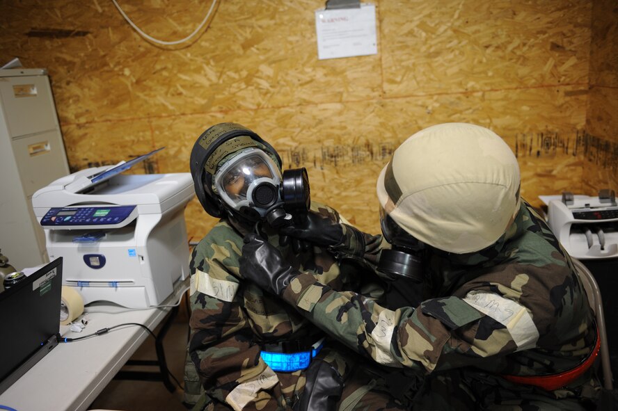 DYESS AIR FORCE BASE, Texas—Senior Airman Gregory Showell (left), and Airman 1st Class Tyler Anderson (right), 7th Comptrollers Squadron, conduct buddy checks on each other Nov. 14 during an Operational Readiness Exercise here. OREs are conducted to test the capabilities and efficiencies of Airmen to ensure they are prepared for real world events. (U.S Air Force photo/ Airman 1st Class Shannon Hall)  
