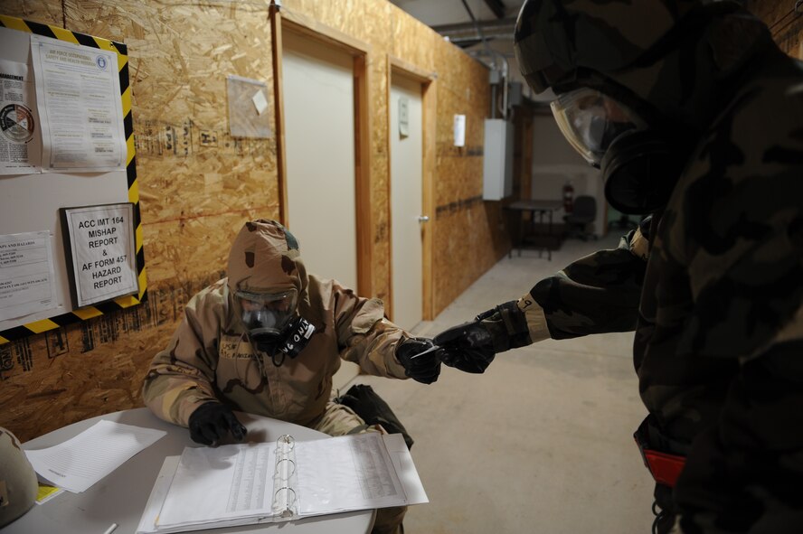 DYESS AIR FORCE BASE, Texas—Airman 1st Class Steven Marking, 7th Operations Support Squadron, checks the identification card of Airman 1st Class Evan Mills, 7th Bomb Wing Public Affairs, Nov. 14 during an Operational Readiness Exercise here. OREs are conducted to test the capabilities and efficiencies of Airmen to ensure they are prepared for real world events. (U.S Air Force photo/ Airman 1st Class Shannon Hall)  