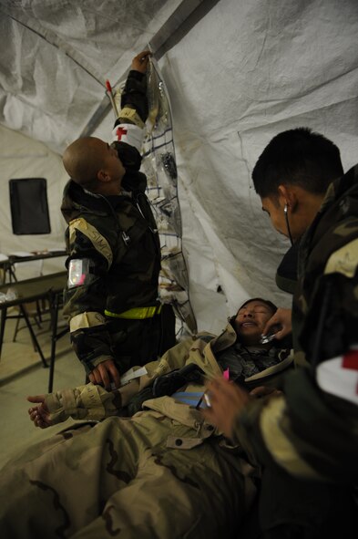 DYESS AIR FORCE BASE, Texas—Senior Airman Seurnchiew Saephan (left), and Staff Sgt. Andrew Estacion (right), 7th Medical Operations Squadron, check the vital signs of Staff Sgt. Ana Muniz, 7th MDOS, Nov. 14 during an Operational Readiness Exercise here. OREs are conducted to test the capabilities and efficiencies of Airmen to ensure they are prepared for real world events. (U.S Air Force photo/ Airman 1st Class Shannon Hall)  